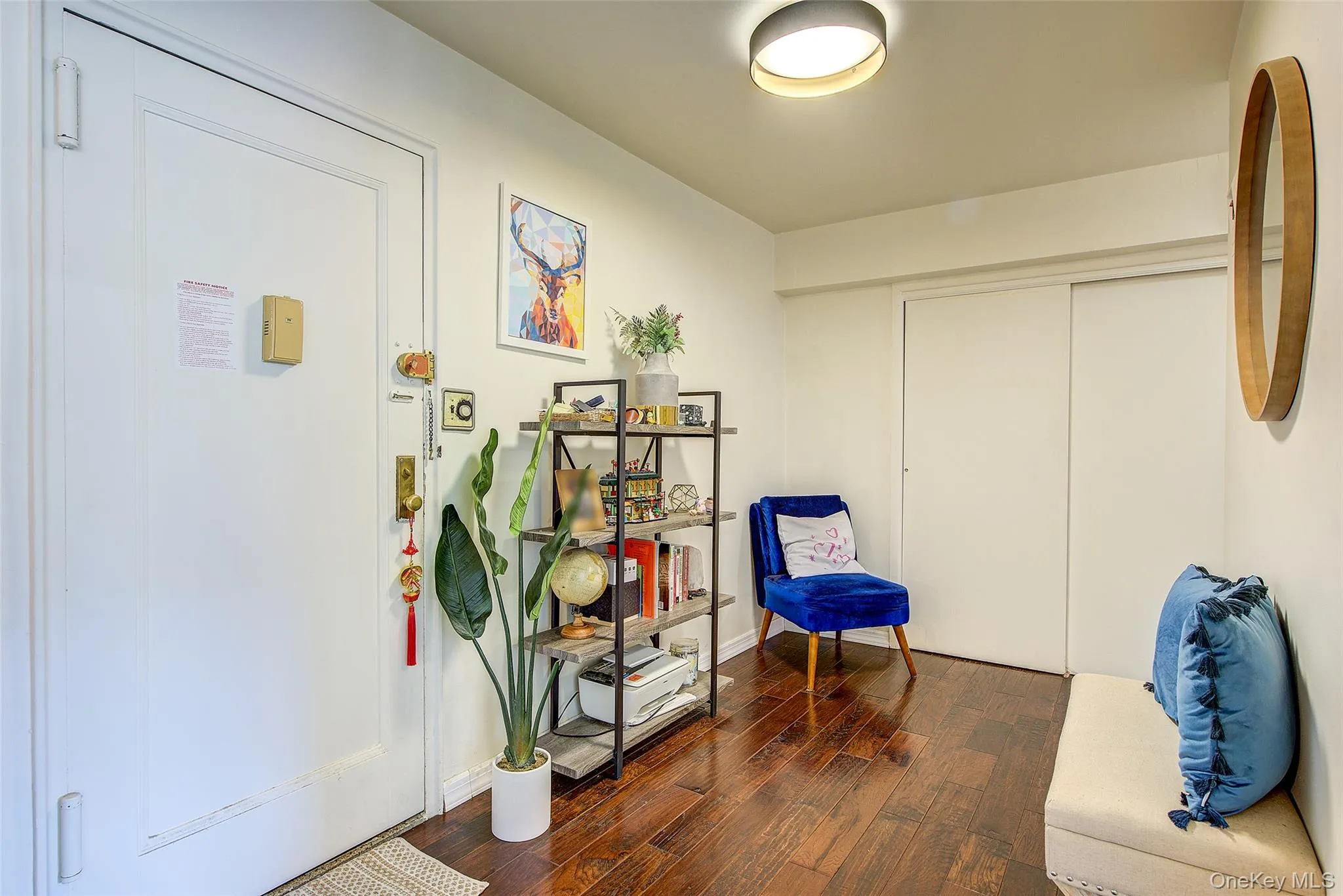 Living area with dark wood-type flooring and baseboards Living area with dark wood-type flooring and baseboards