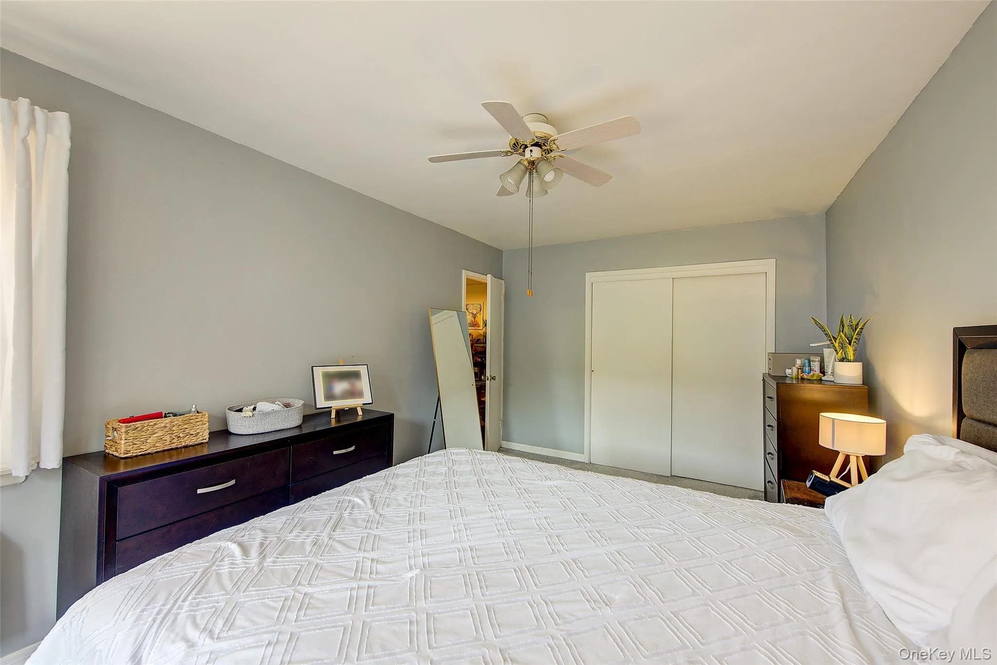 Bedroom featuring a closet and ceiling fan Bedroom featuring a closet and ceiling fan