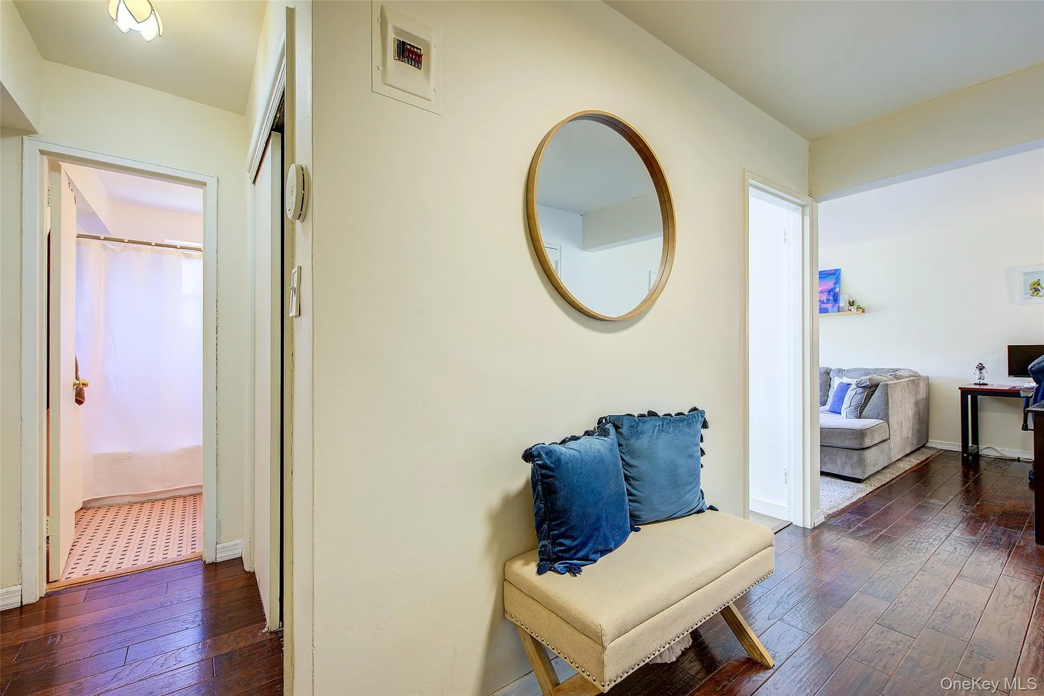 Hallway featuring dark wood finished floors and baseboards Hallway featuring dark wood finished floors and baseboards