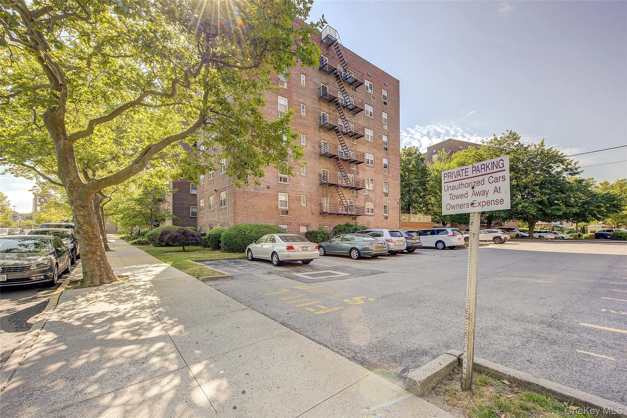 View of apartment building / complex featuring uncovered parking View of apartment building / complex featuring uncovered parking