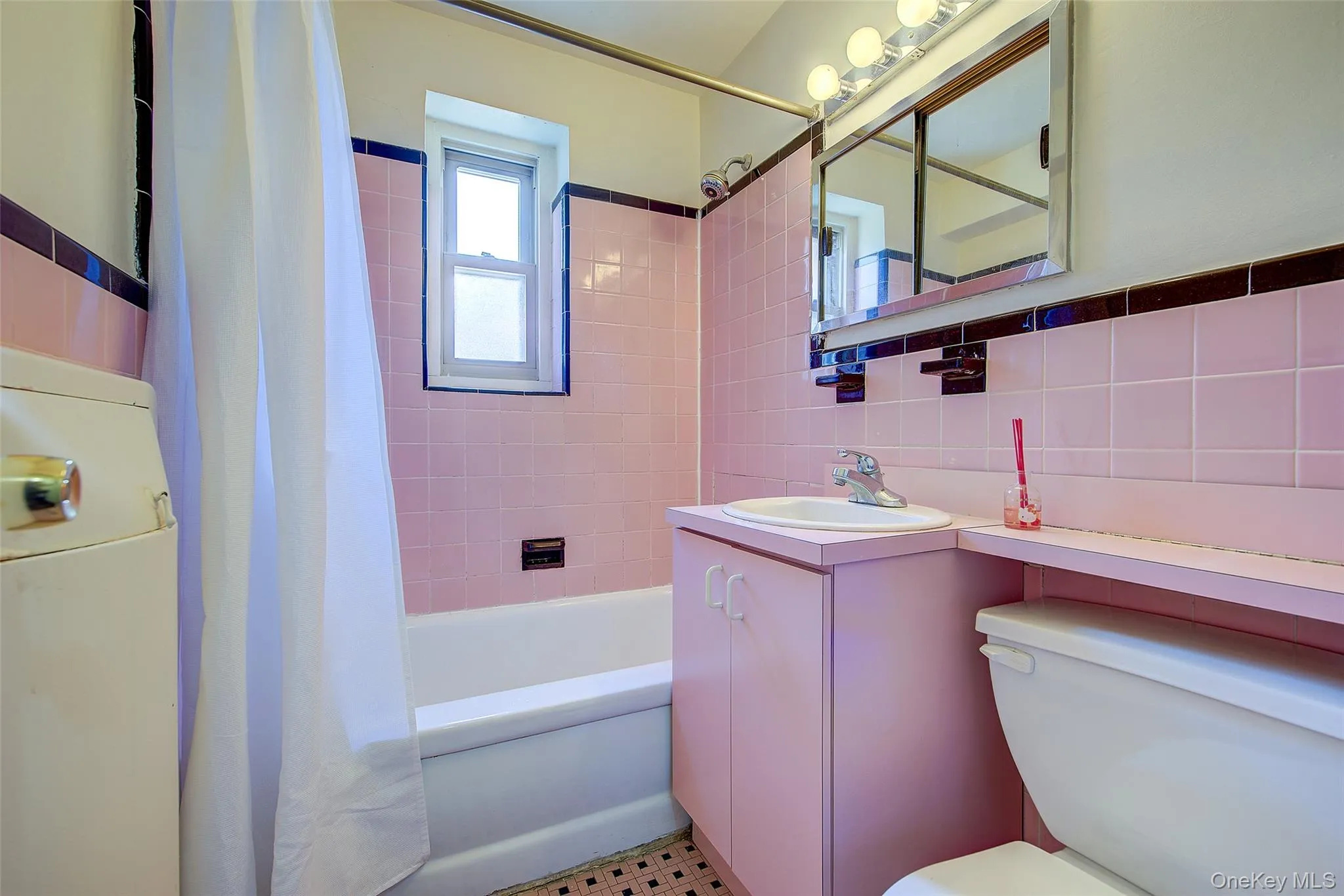 Bathroom with shower / tub combo, tile walls, vanity, and tasteful backsplash Bathroom with shower / tub combo, tile walls, vanity, and tasteful backsplash