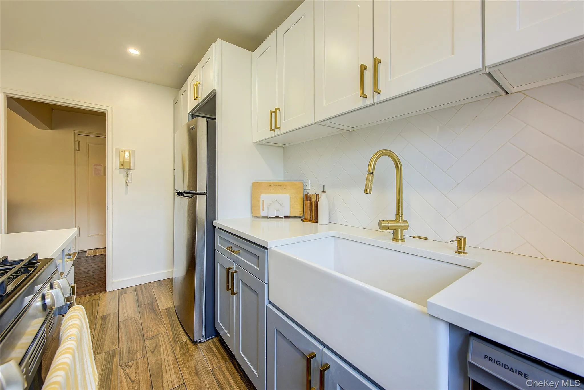 Kitchen with appliances with stainless steel finishes, tasteful backsplash, light countertops, recessed lighting, and white cabinets Kitchen with appliances with stainless steel finishes, tasteful backsplash, light countertops, recessed lighting, and white cabinets