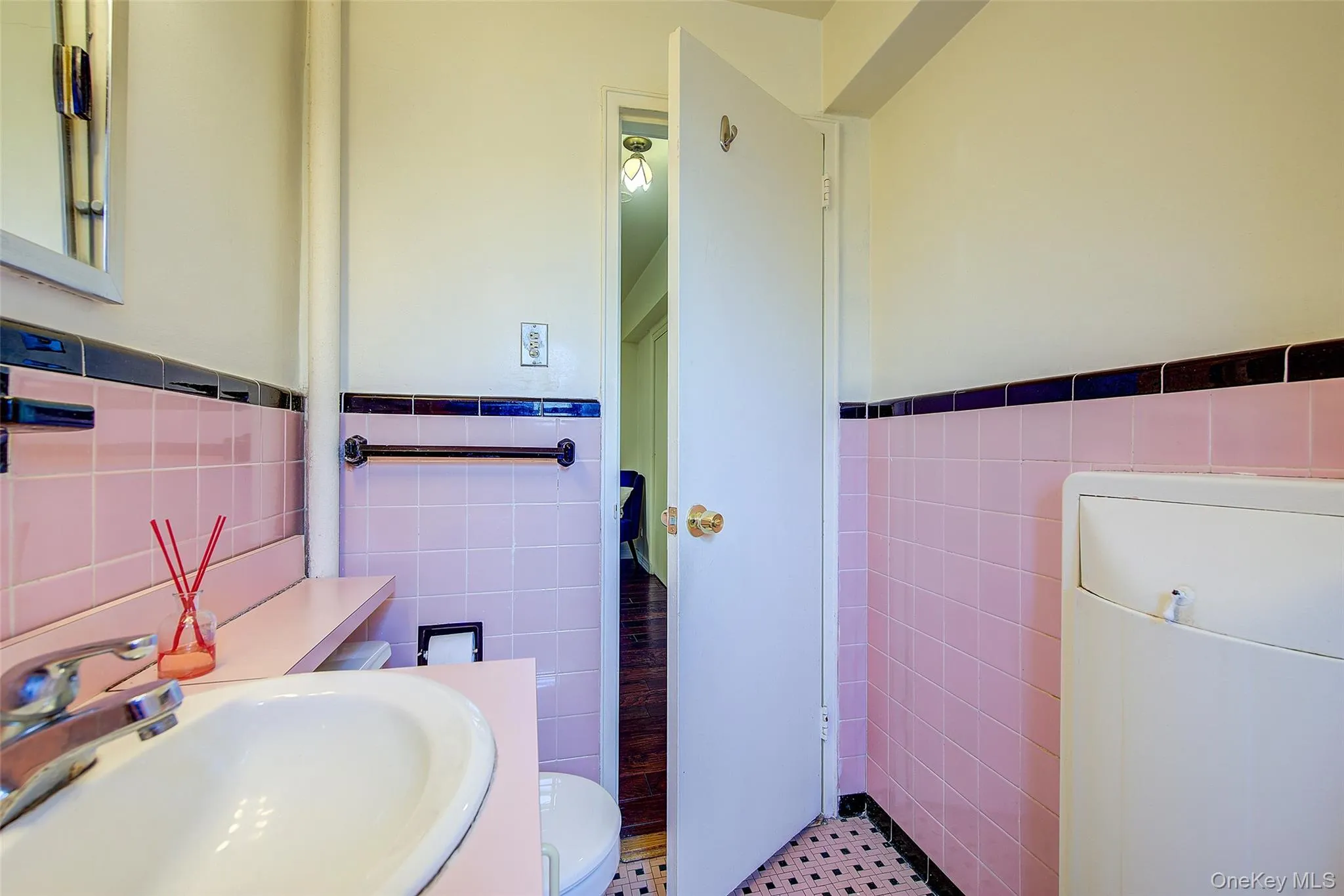 Half bath with tile walls, wainscoting, and vanity Half bath with tile walls, wainscoting, and vanity