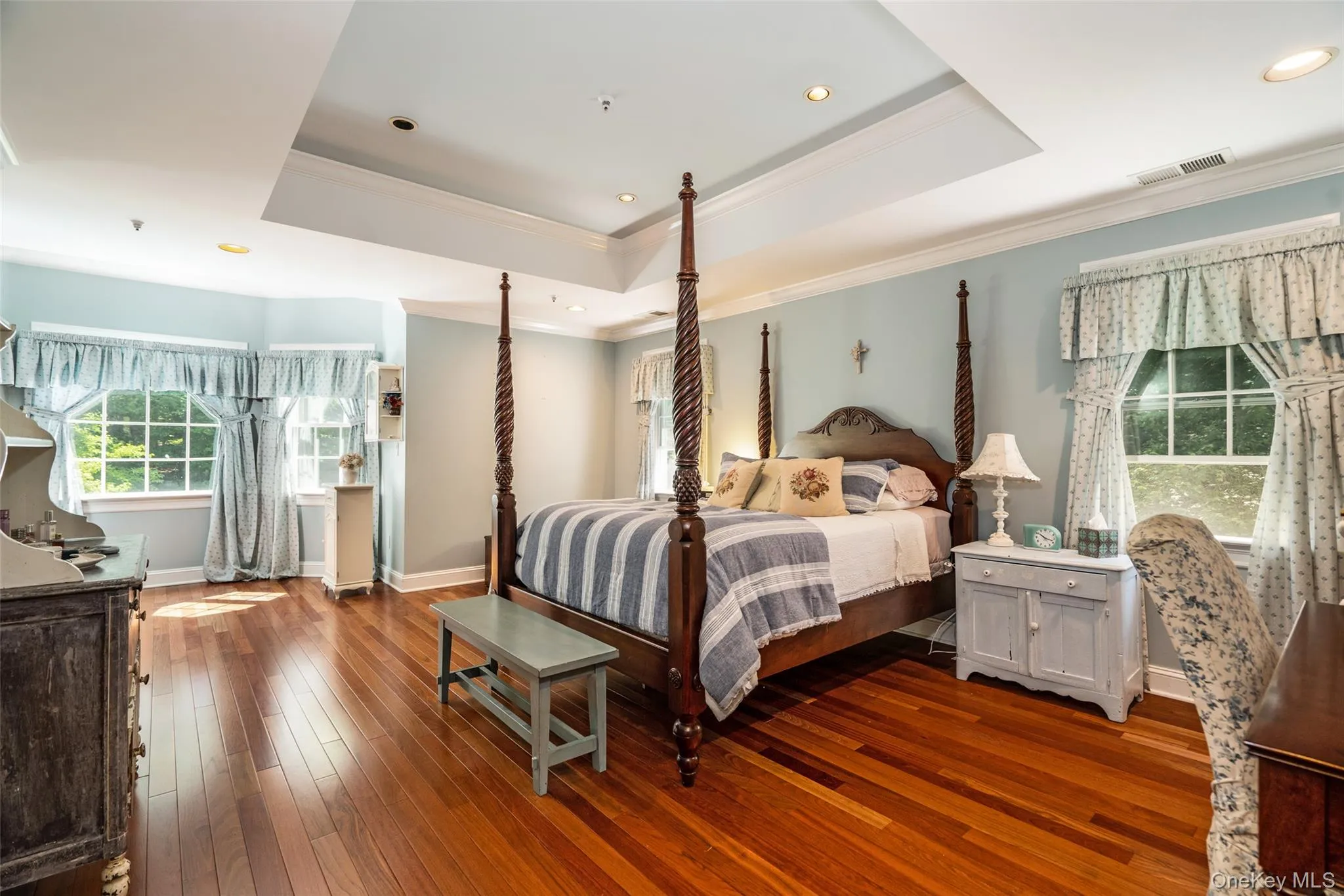 This primary suite is your own personal retreat. With elegant tray ceilings and a dedicated sitting area, it's the perfect place to reset after a long day. This primary suite is your own personal retreat. With elegant tray ceilings and a dedicated sitting area, it's the perfect place to reset after a long day.