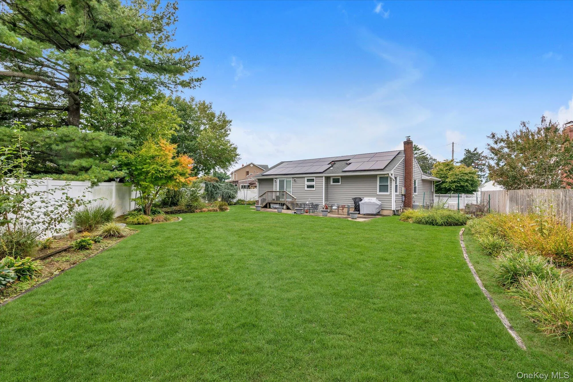 Expansive green lawn with mature perimeter landscaping Expansive green lawn with mature perimeter landscaping