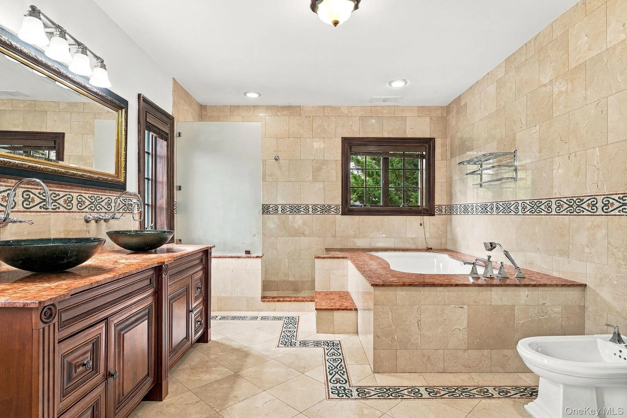 A marble-and-granite bath worthy of the primary suite. A marble-and-granite bath worthy of the primary suite.