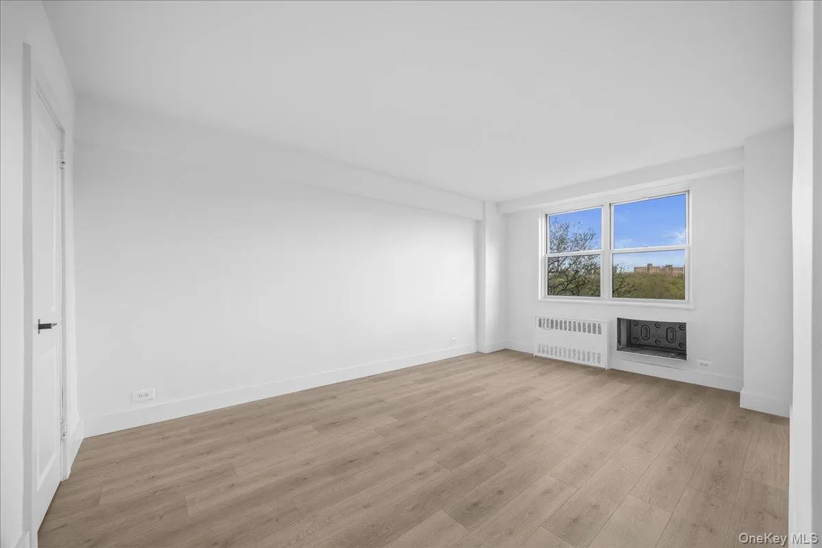 Bright interior with vinyl flooring and a large window Bright interior with vinyl flooring and a large window