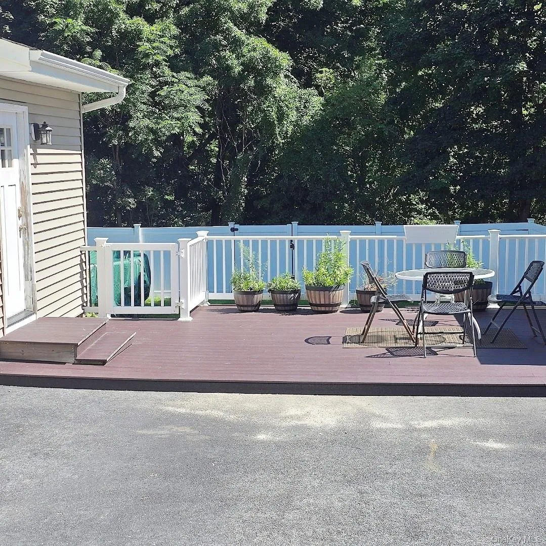 Spacious side exterior deck with composite decking and white railing Spacious side exterior deck with composite decking and white railing