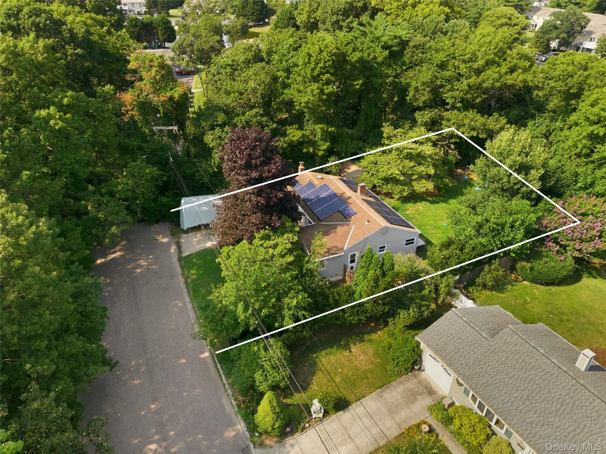 Single-story residence with a gabled roof and solar panels Single-story residence with a gabled roof and solar panels