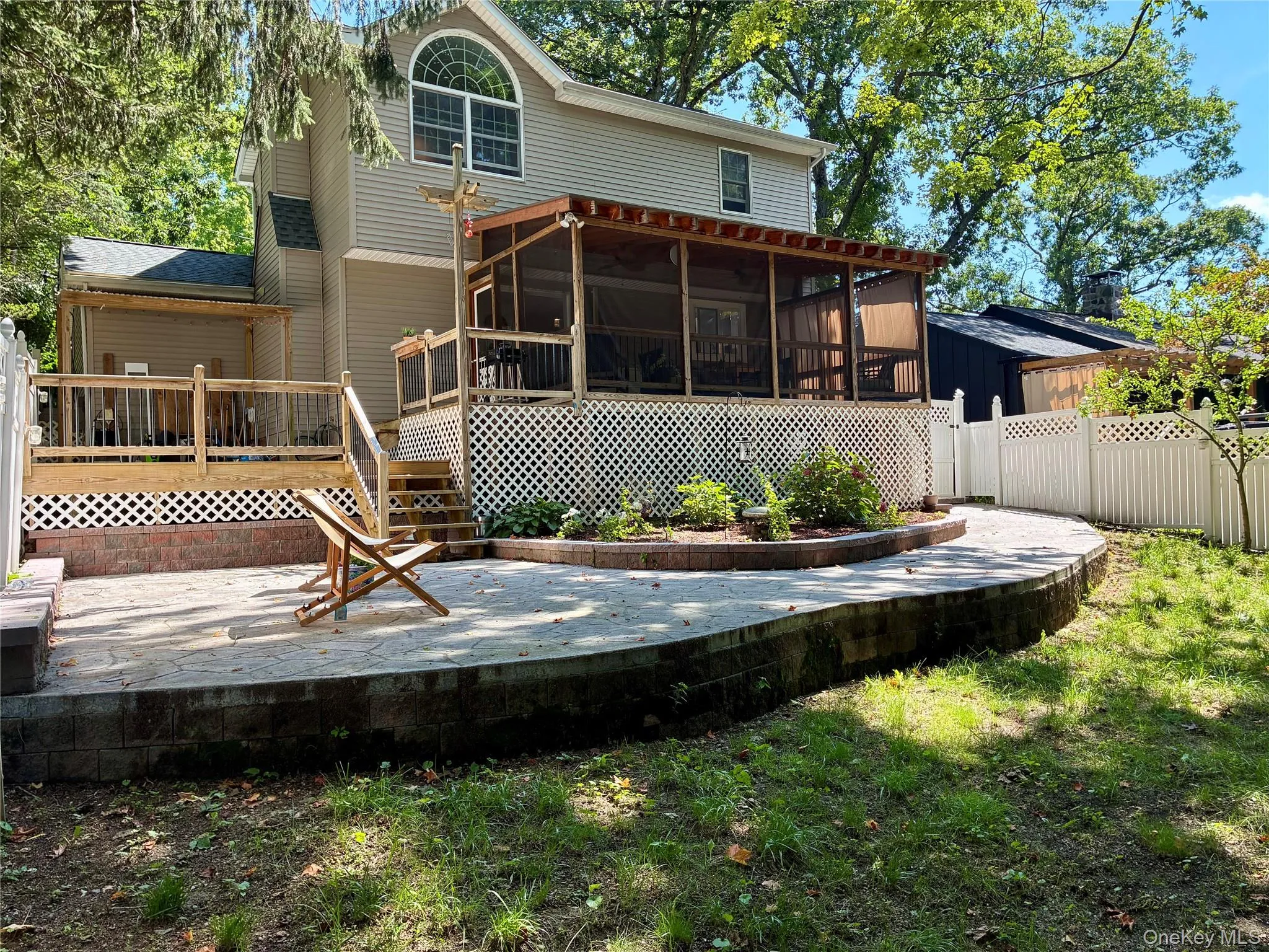 View of back of property featuring deck area, patio and garden space. View of back of property featuring deck area, patio and garden space.