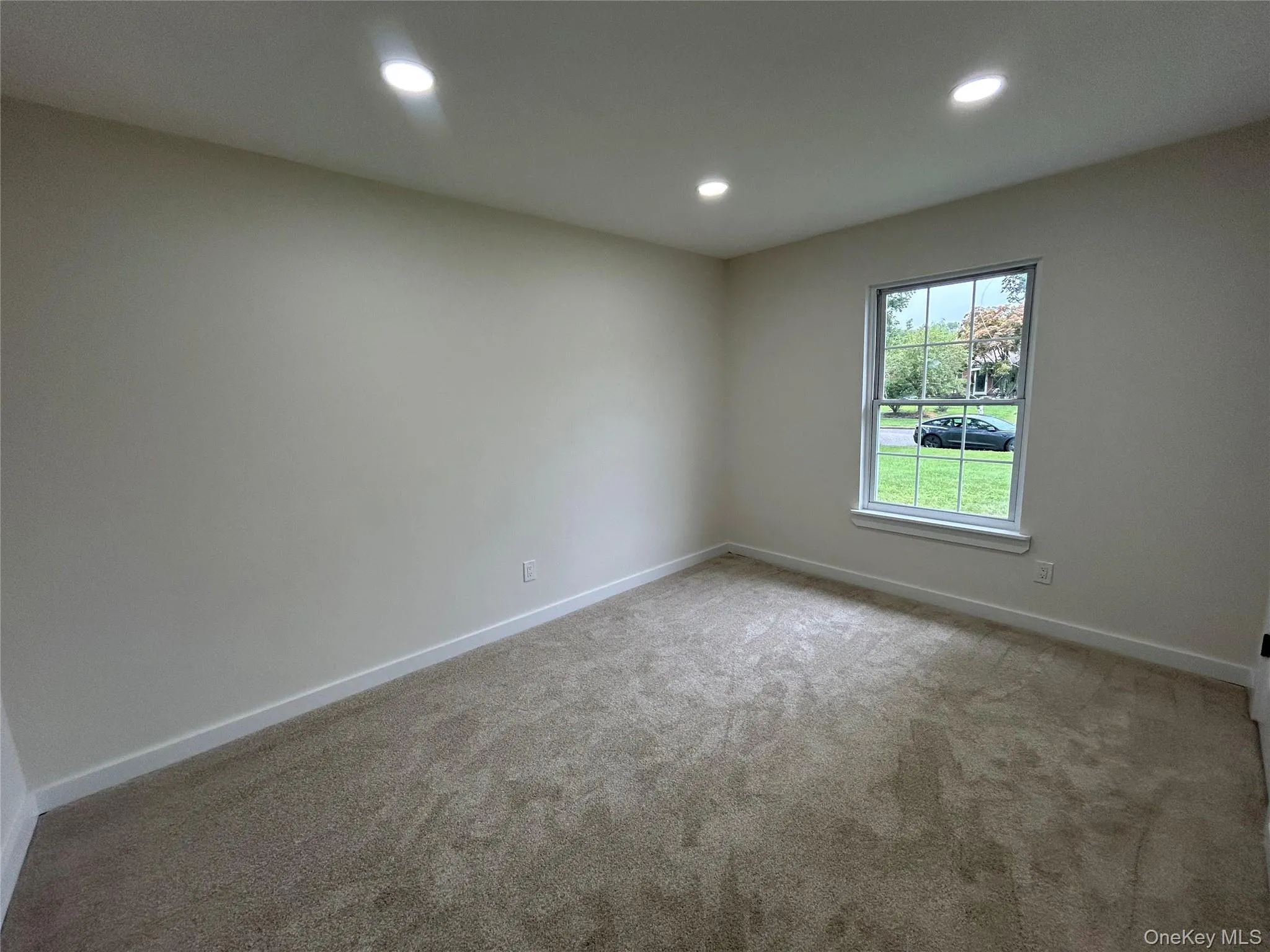 Bedroom with recessed lighting and new carpeting Bedroom with recessed lighting and new carpeting