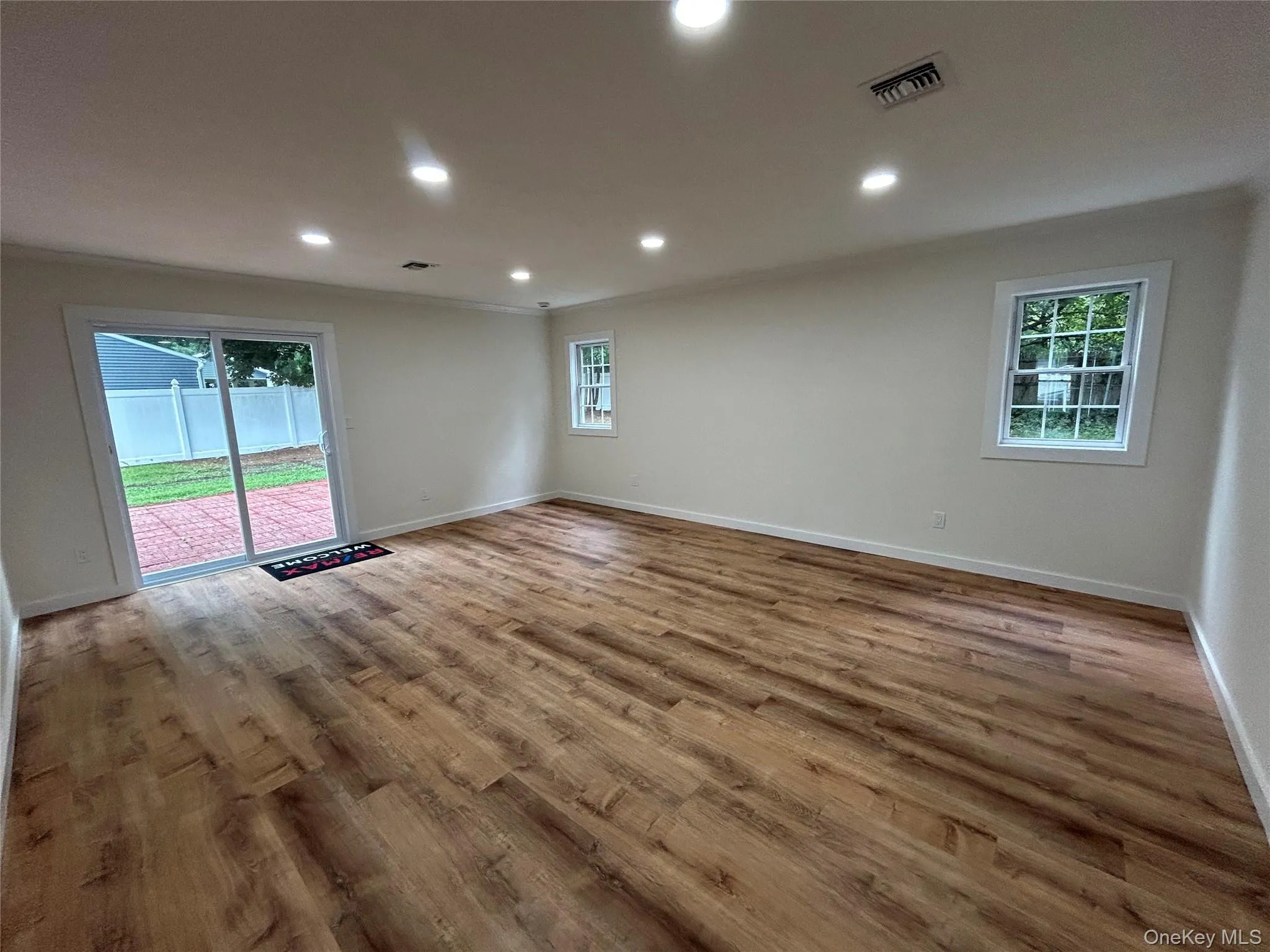 Den with new: sliding glass doors, recessed lighting and flooring Den with new: sliding glass doors, recessed lighting and flooring