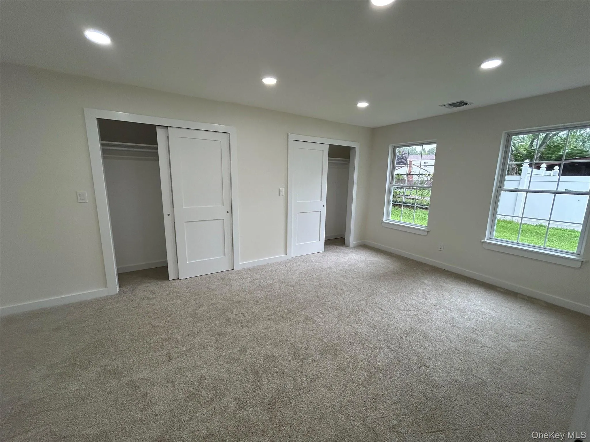 Bedroom with double closet and new carpeting Bedroom with double closet and new carpeting