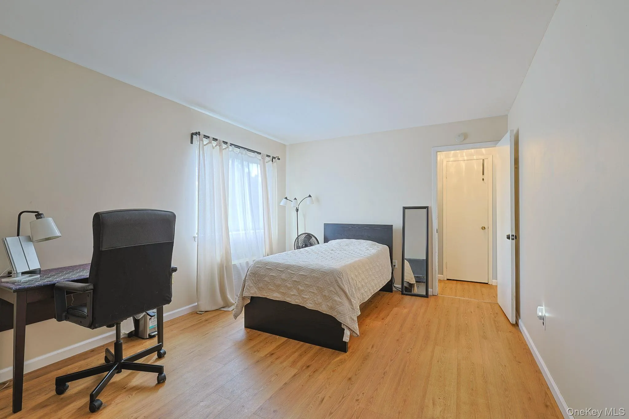 Primary bedroom featuring wood-finish flooring Primary bedroom featuring wood-finish flooring