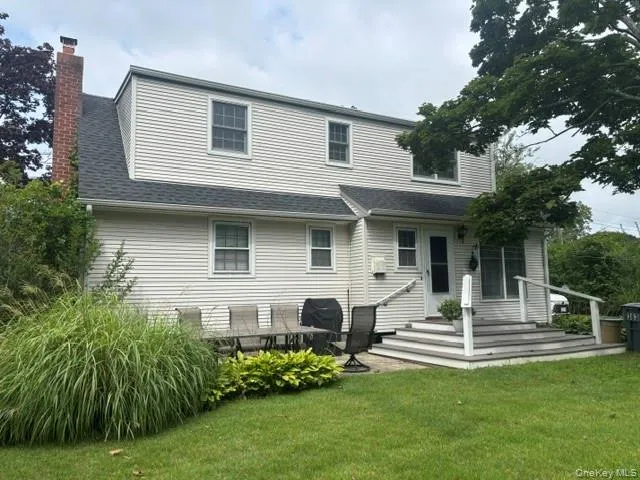 Full Rear Dormer with a brick chimney, a multi-tier deck, and a paver patio Full Rear Dormer with a brick chimney, a multi-tier deck, and a paver patio