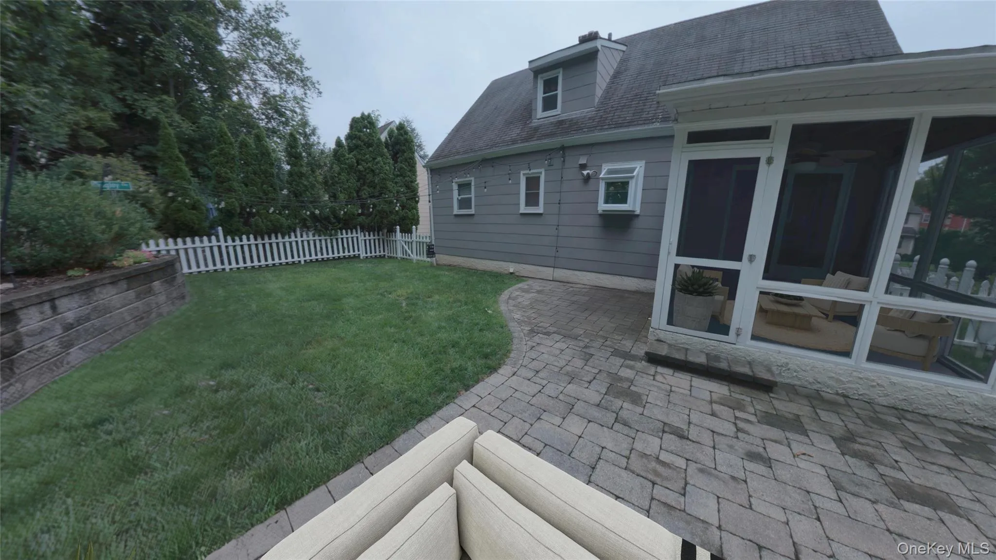Paved outdoor patio with fully fenced yard. Paved outdoor patio with fully fenced yard.