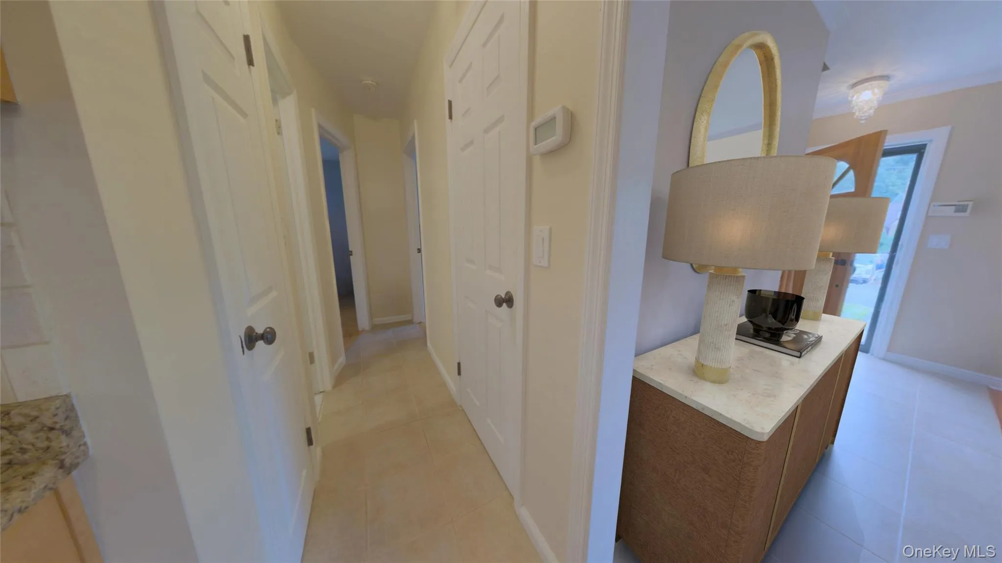 Hallway from the Kitchen to the downstairs bathroom, and bedrooms. Stairs lead down to basement. Hallway from the Kitchen to the downstairs bathroom, and bedrooms. Stairs lead down to basement.
