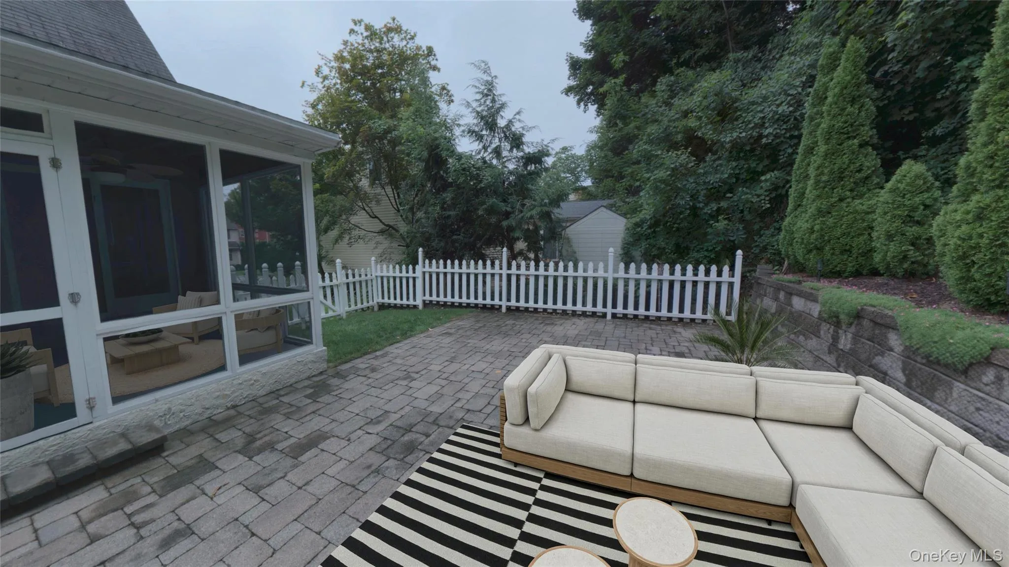 Paved outdoor patio with fully fenced yard. Paved outdoor patio with fully fenced yard.