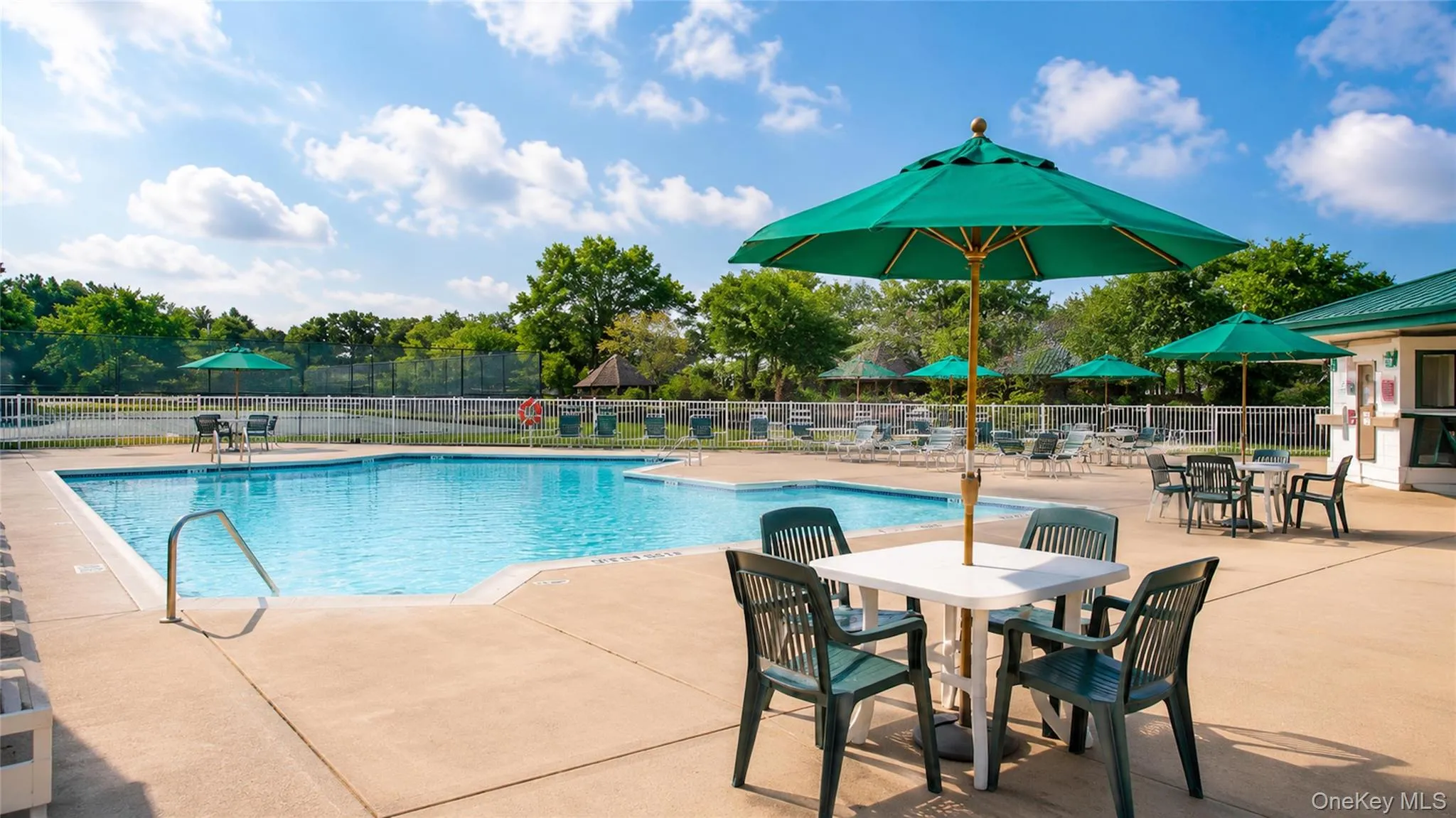Sparkling community pool with ample seating and shaded tables provides an inviting setting for summer recreation. Sparkling community pool with ample seating and shaded tables provides an inviting setting for summer recreation.