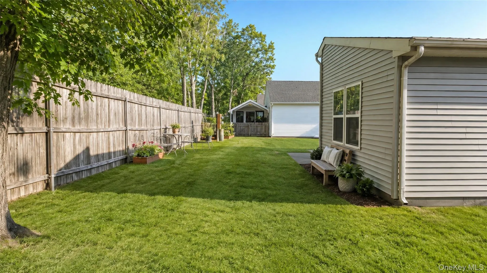 A generous green lawn framed by mature trees and fencing creates a private and inviting outdoor retreat. A generous green lawn framed by mature trees and fencing creates a private and inviting outdoor retreat.