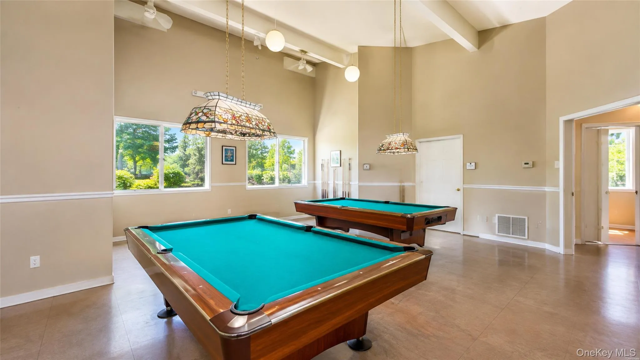 Spacious community billiards room offers a comfortable indoor gathering space for recreation and social activities Spacious community billiards room offers a comfortable indoor gathering space for recreation and social activities
