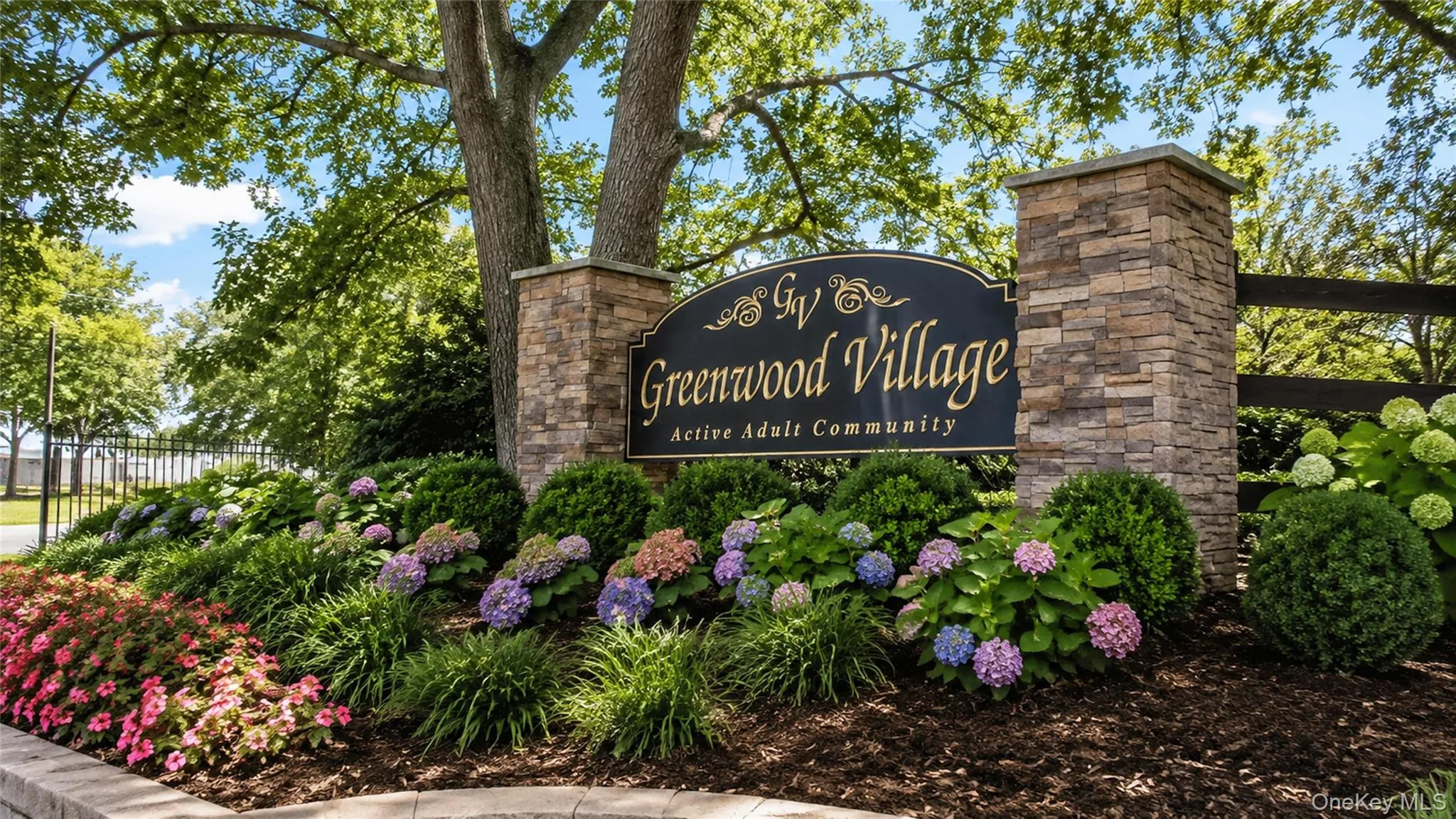 Welcoming entrance to Greenwood Village, an established active-adult community surrounded by mature landscaping and colorful seasonal plantings. Welcoming entrance to Greenwood Village, an established active-adult community surrounded by mature landscaping and colorful seasonal plantings.