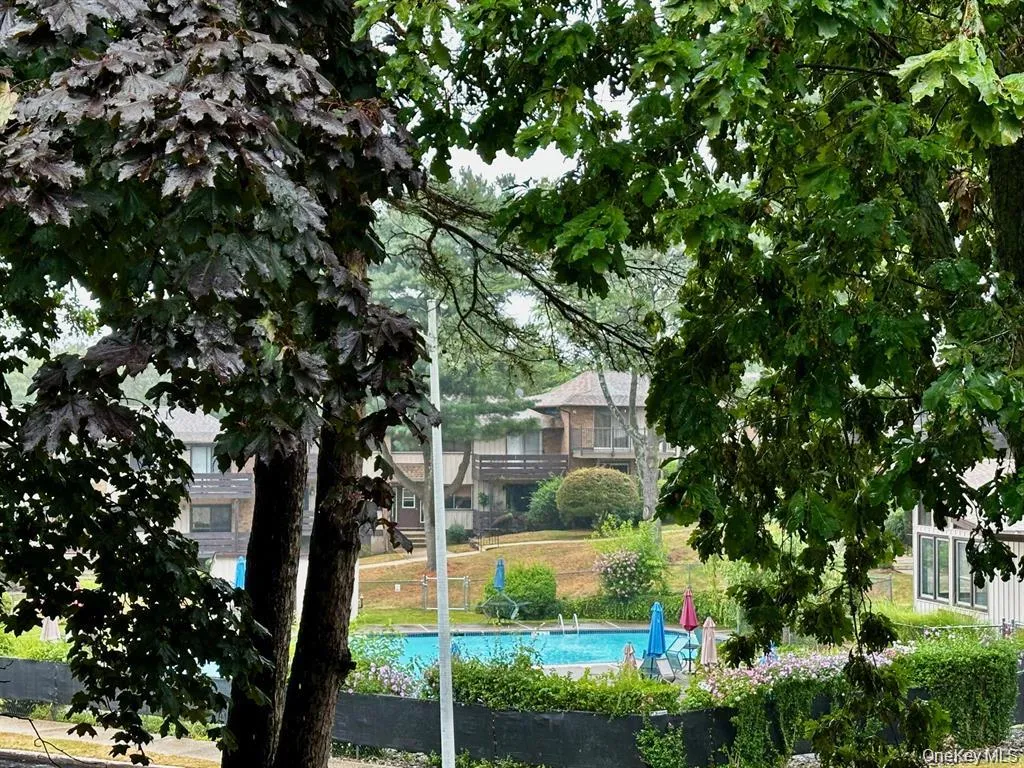 Beautiful view from the private deck overlooking one of the community pools and surrounding green space. Beautiful view from the private deck overlooking one of the community pools and surrounding green space.