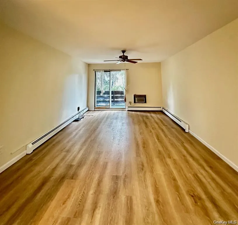 Spacious living room with gleaming flooring and sliding glass doors to your private covered deck bringing in plenty of natural light. Spacious living room with gleaming flooring and sliding glass doors to your private covered deck bringing in plenty of natural light.