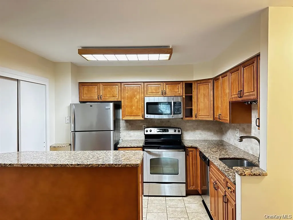 Functional kitchen with stainless steel appliances, ample cabinetry and counter space, plus a pantry for additional storage. Functional kitchen with stainless steel appliances, ample cabinetry and counter space, plus a pantry for additional storage.