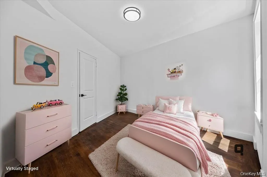 Hardwood flooring throughout, bright white walls, flush mount ceiling light fixture, white door with black hardware, and an expansive window Hardwood flooring throughout, bright white walls, flush mount ceiling light fixture, white door with black hardware, and an expansive window