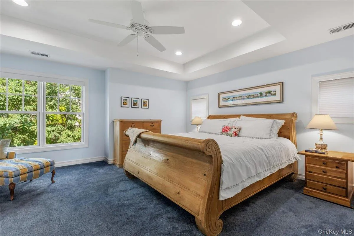 Spacious primary bedroom with tray ceiling Spacious primary bedroom with tray ceiling