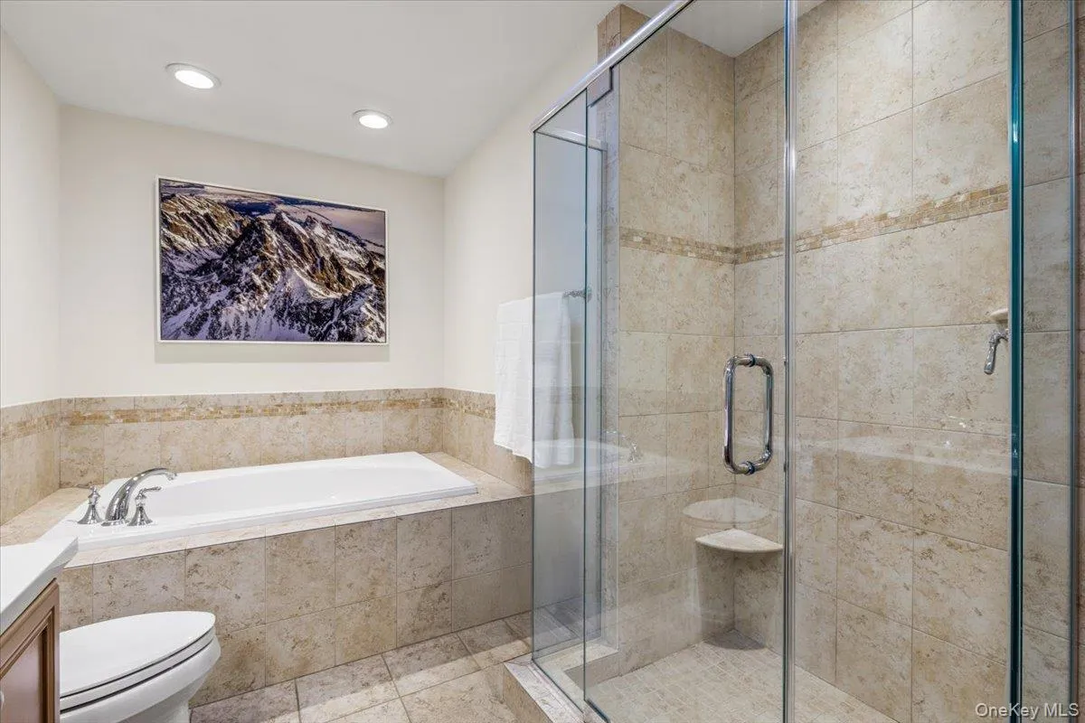 Primary bath with separate glass-enclosed shower Primary bath with separate glass-enclosed shower