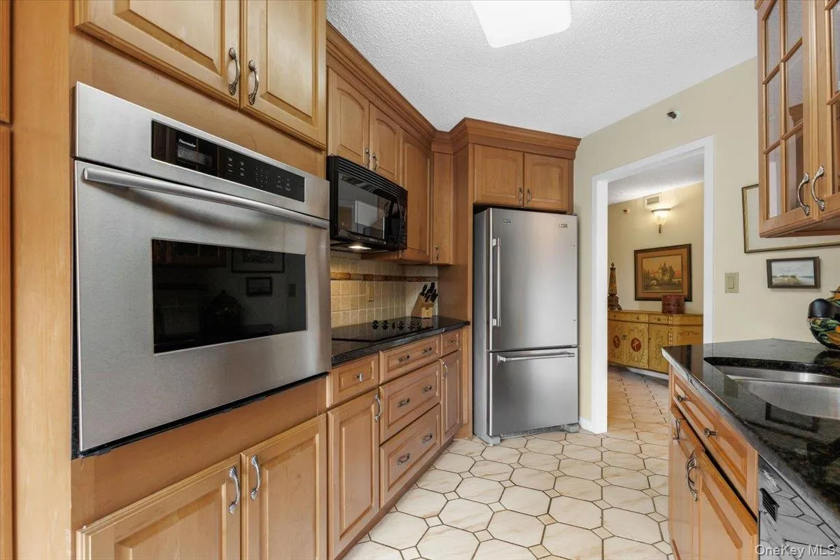 Walk-through kitchen with stainless steel appliances. Walk-through kitchen with stainless steel appliances.
