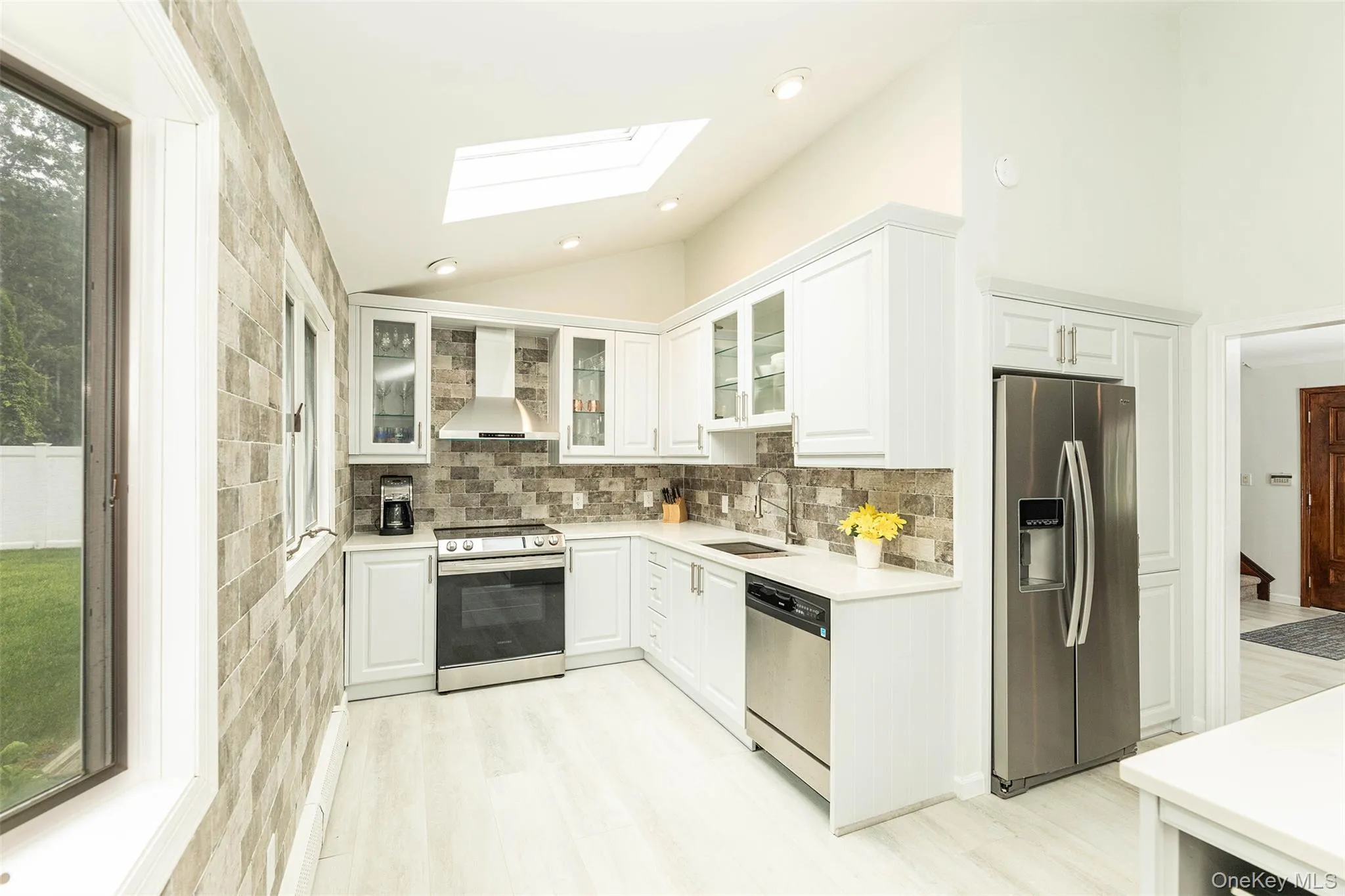 White shaker cabinetry with glass-front display cabinets. White shaker cabinetry with glass-front display cabinets.