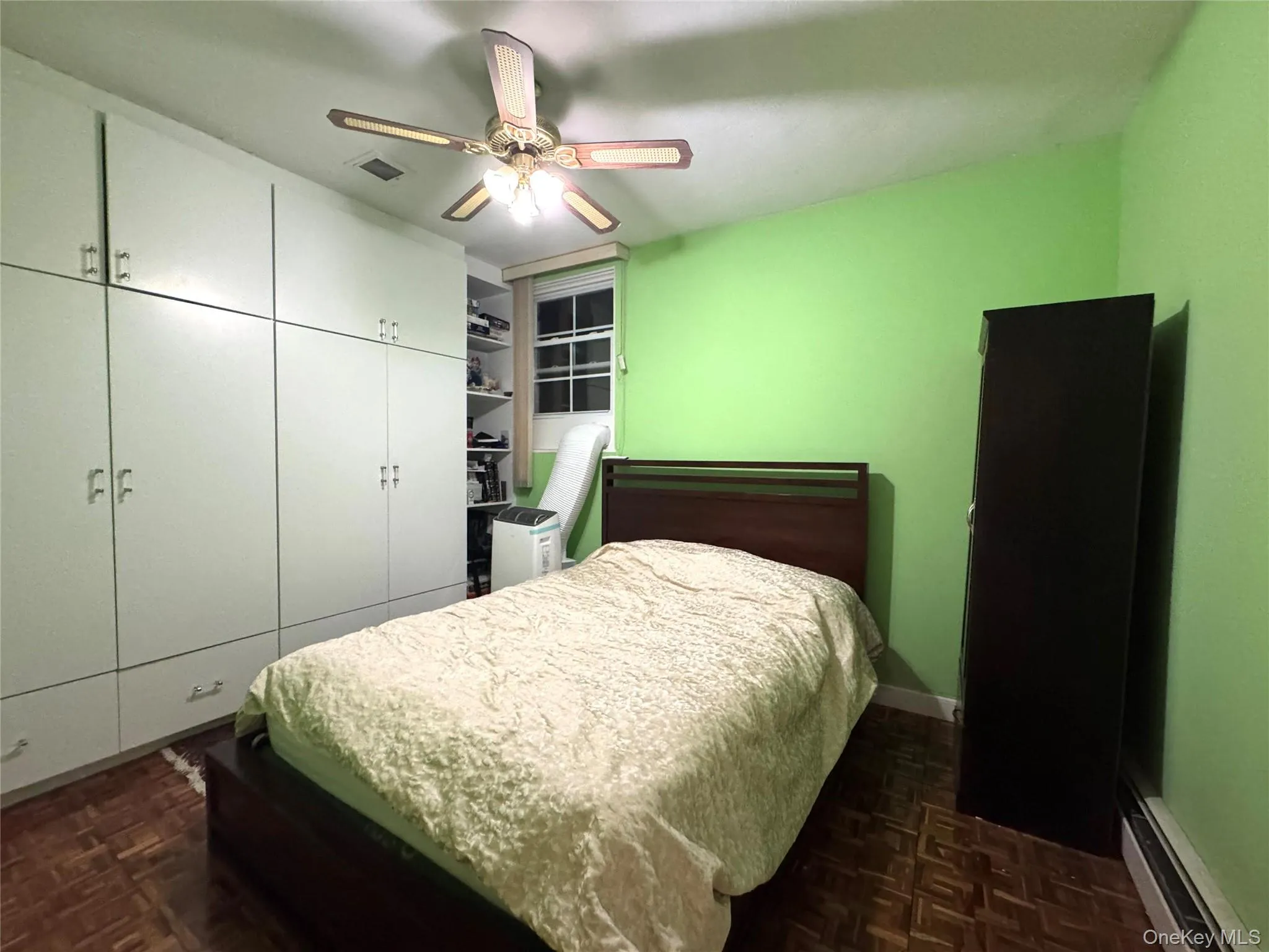 Built-in cabinetry with ample storage, wood-finish flooring, and ceiling fan Built-in cabinetry with ample storage, wood-finish flooring, and ceiling fan