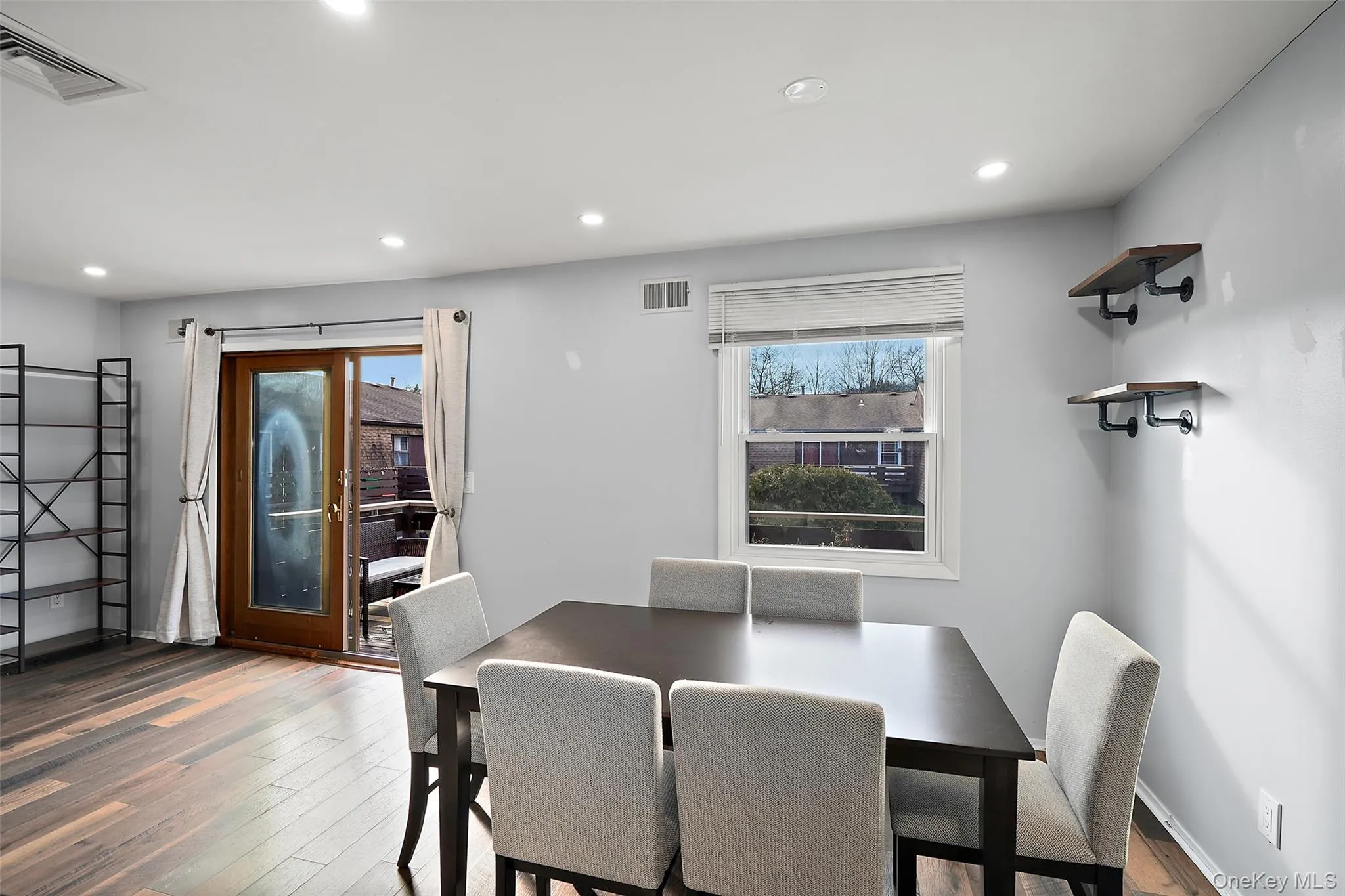 Dining space with dark hardwood / wood-style flooring Dining space with dark hardwood / wood-style flooring
