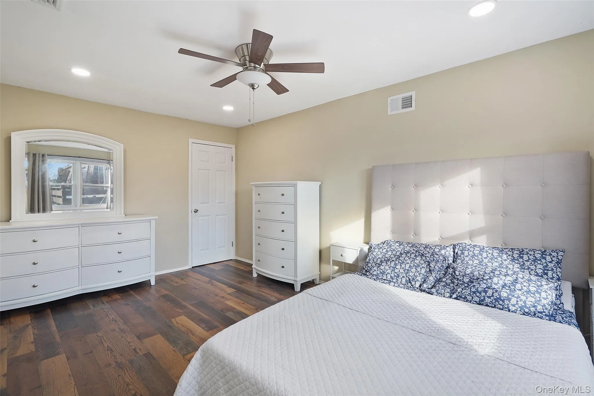 Bedroom with ceiling fan and dark hardwood / wood-style flooring Bedroom with ceiling fan and dark hardwood / wood-style flooring