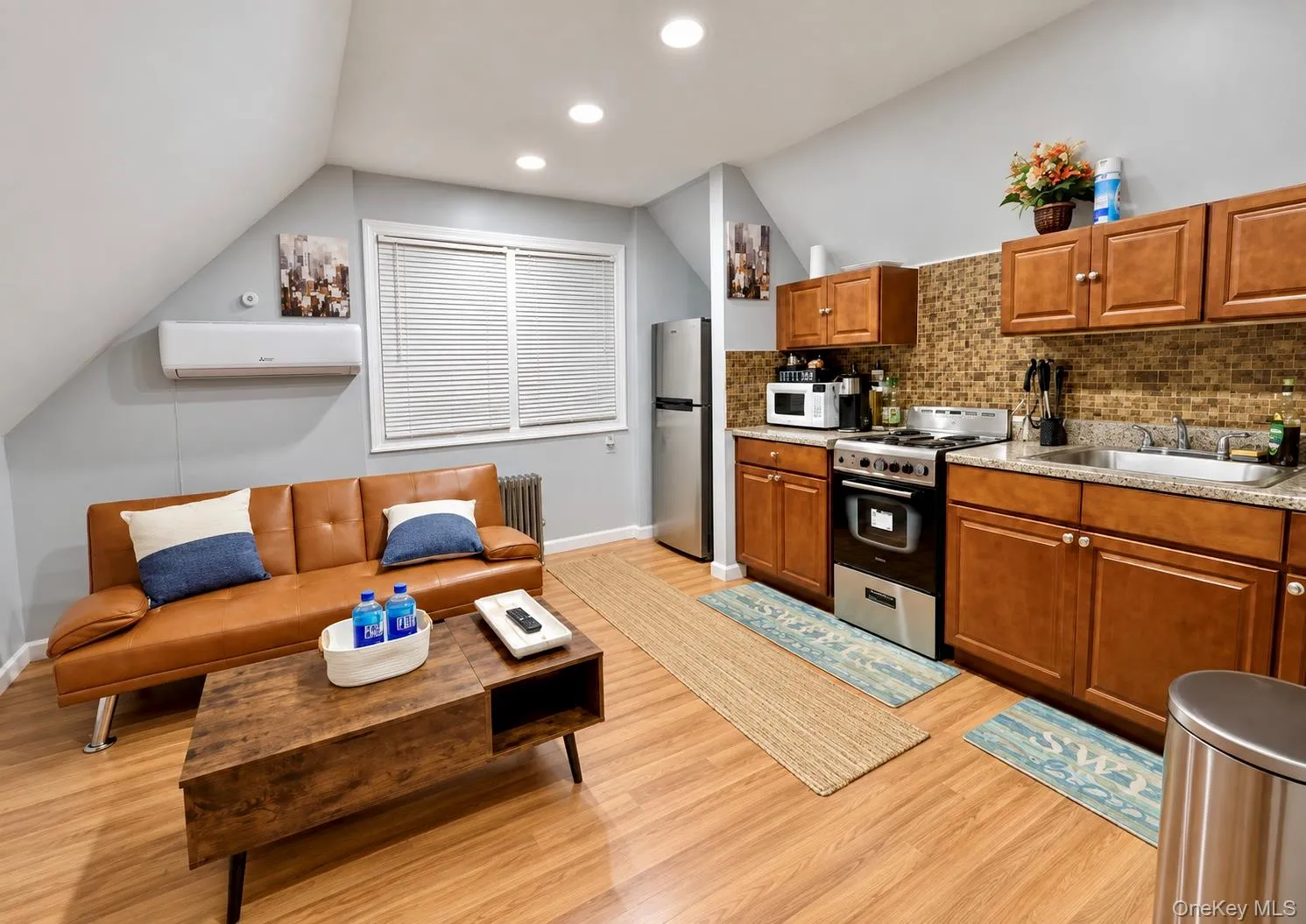 Second-floor bedroom utilized as a kitchen and living room area. Second-floor bedroom utilized as a kitchen and living room area.