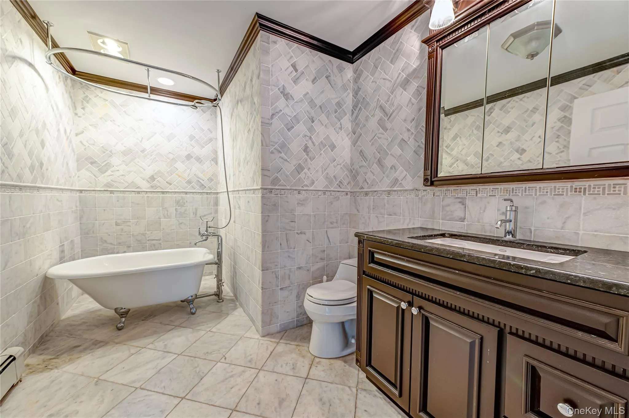 Clawfoot tub with an overhead shower and curved shower rod Clawfoot tub with an overhead shower and curved shower rod