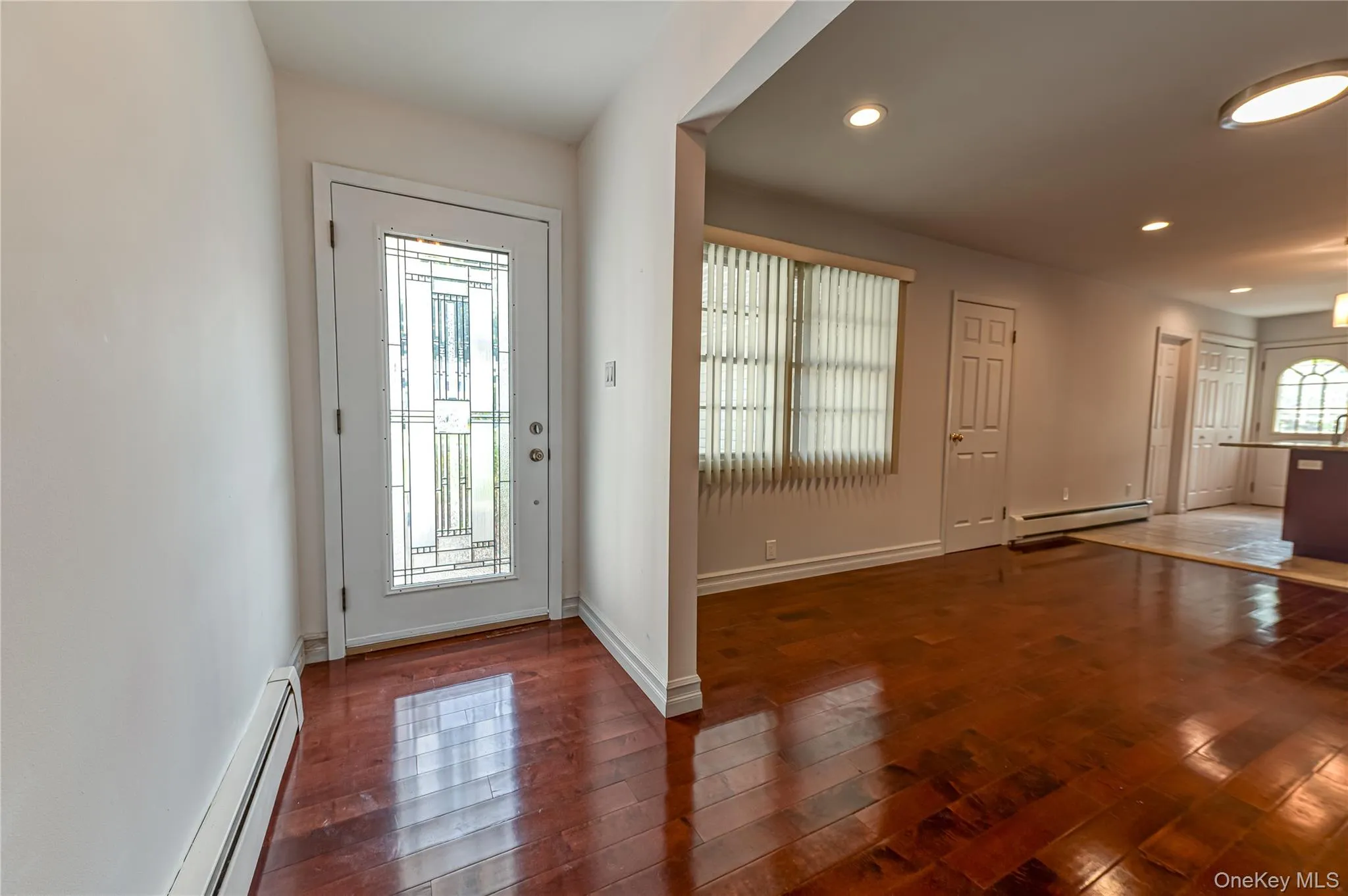 Entryway featuring a decorative glass door, wood-finish flooring, and recessed lighting Entryway featuring a decorative glass door, wood-finish flooring, and recessed lighting
