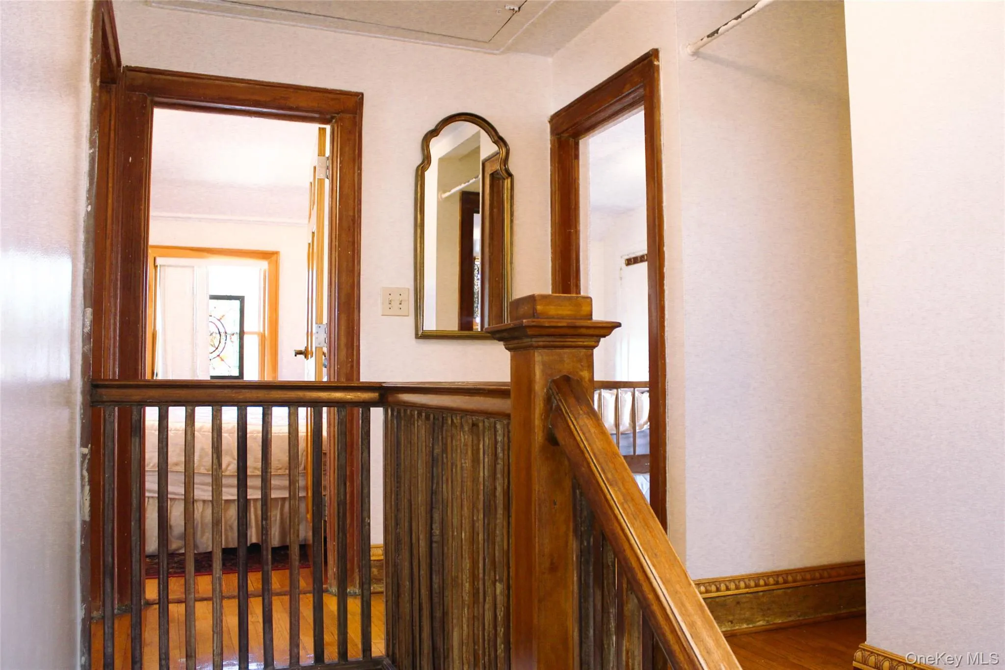 Wood-finish flooring, wood staircase with balusters, and wood door frames Wood-finish flooring, wood staircase with balusters, and wood door frames