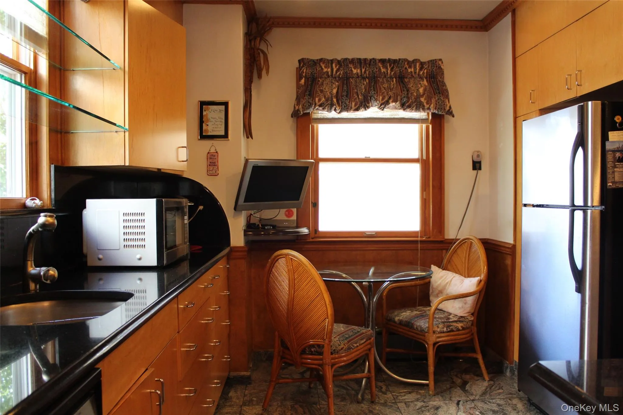Birch wood-finish cabinetry with trash compactor in sink and granites tiles.All stainless steel appliances Birch wood-finish cabinetry with trash compactor in sink and granites tiles.All stainless steel appliances