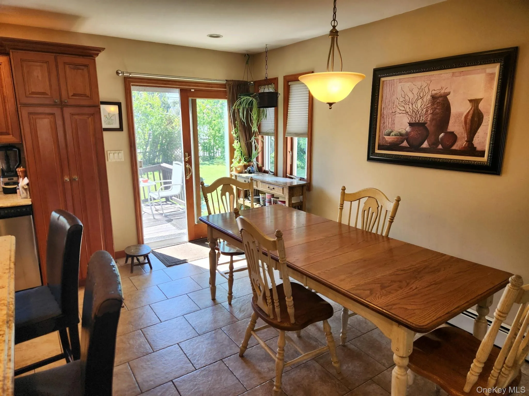 Warm-toned tile flooring, direct outdoor access, built-in cabinetry, recessed lighting, and a suspended ceiling fixture Warm-toned tile flooring, direct outdoor access, built-in cabinetry, recessed lighting, and a suspended ceiling fixture