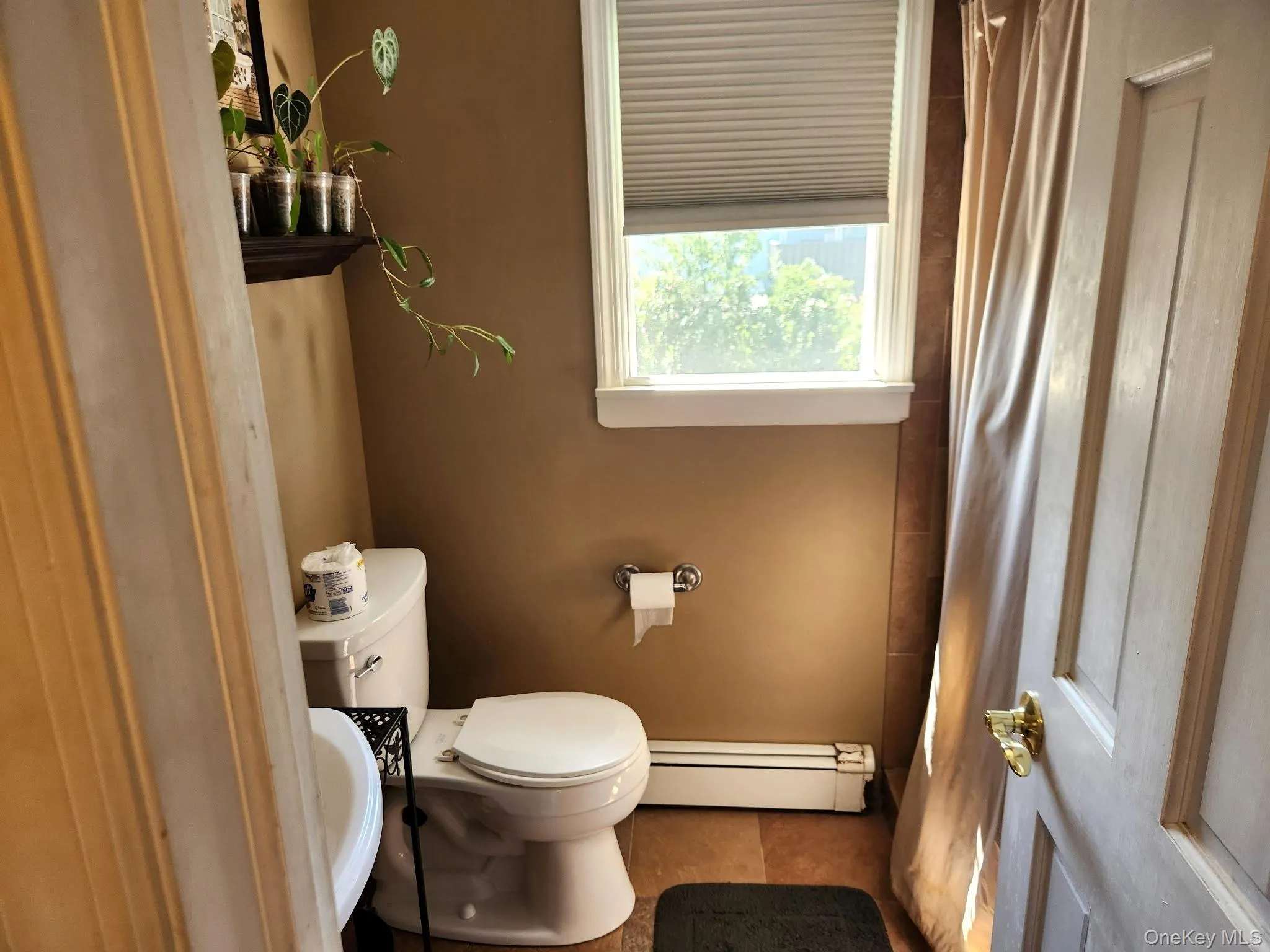 Bathroom with window and cellular shades Bathroom with window and cellular shades