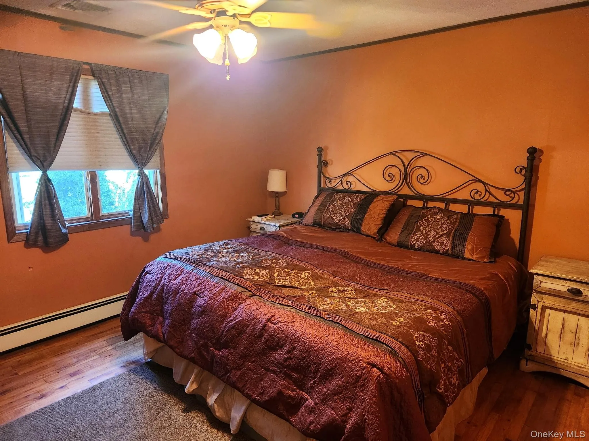 Wood-finish flooring with a ceiling fan light fixture Wood-finish flooring with a ceiling fan light fixture