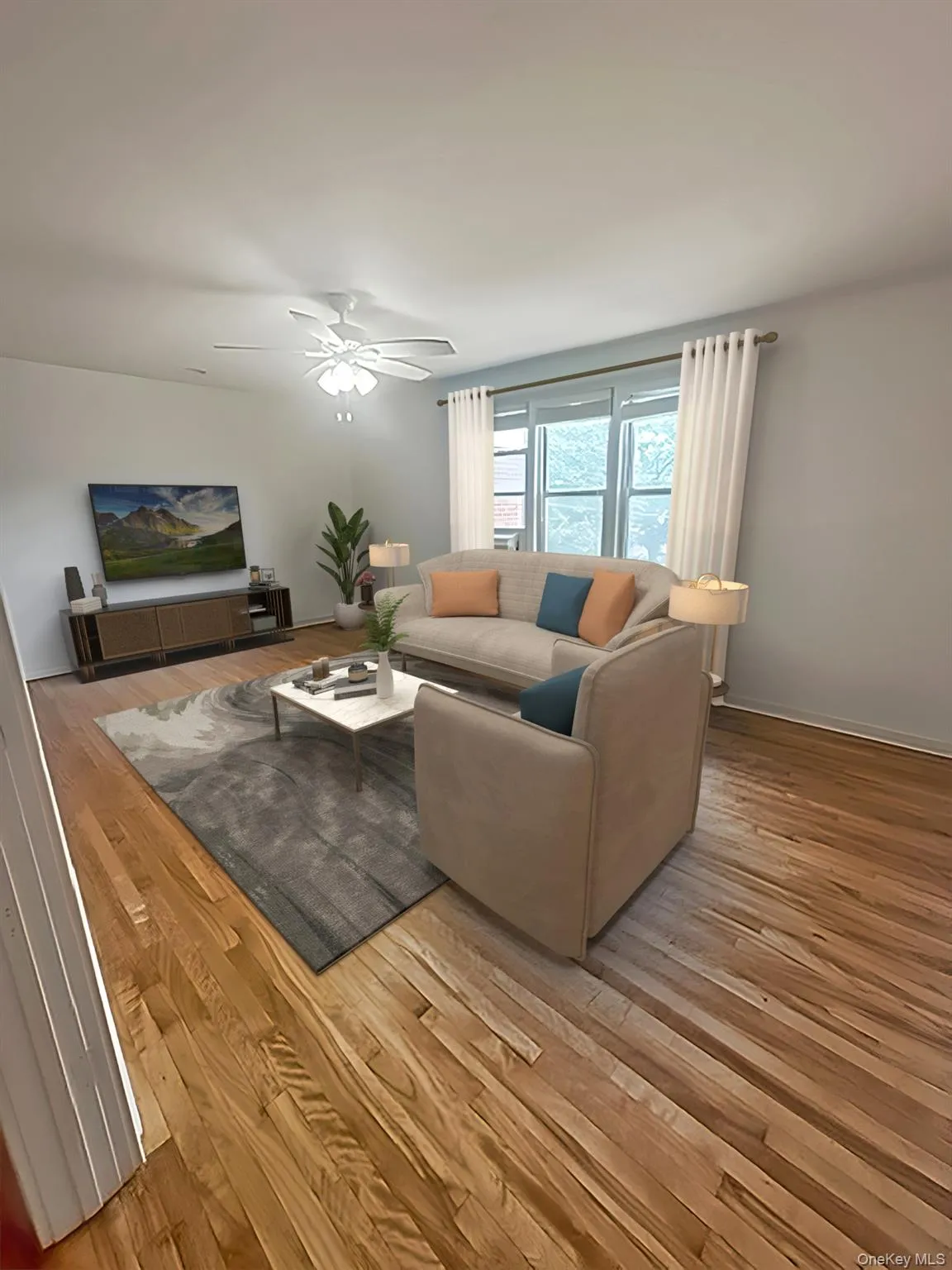 Virtually staged. Beautiful wood floors and large enough to place a dining table on wall not in view in this photo Virtually staged. Beautiful wood floors and large enough to place a dining table on wall not in view in this photo