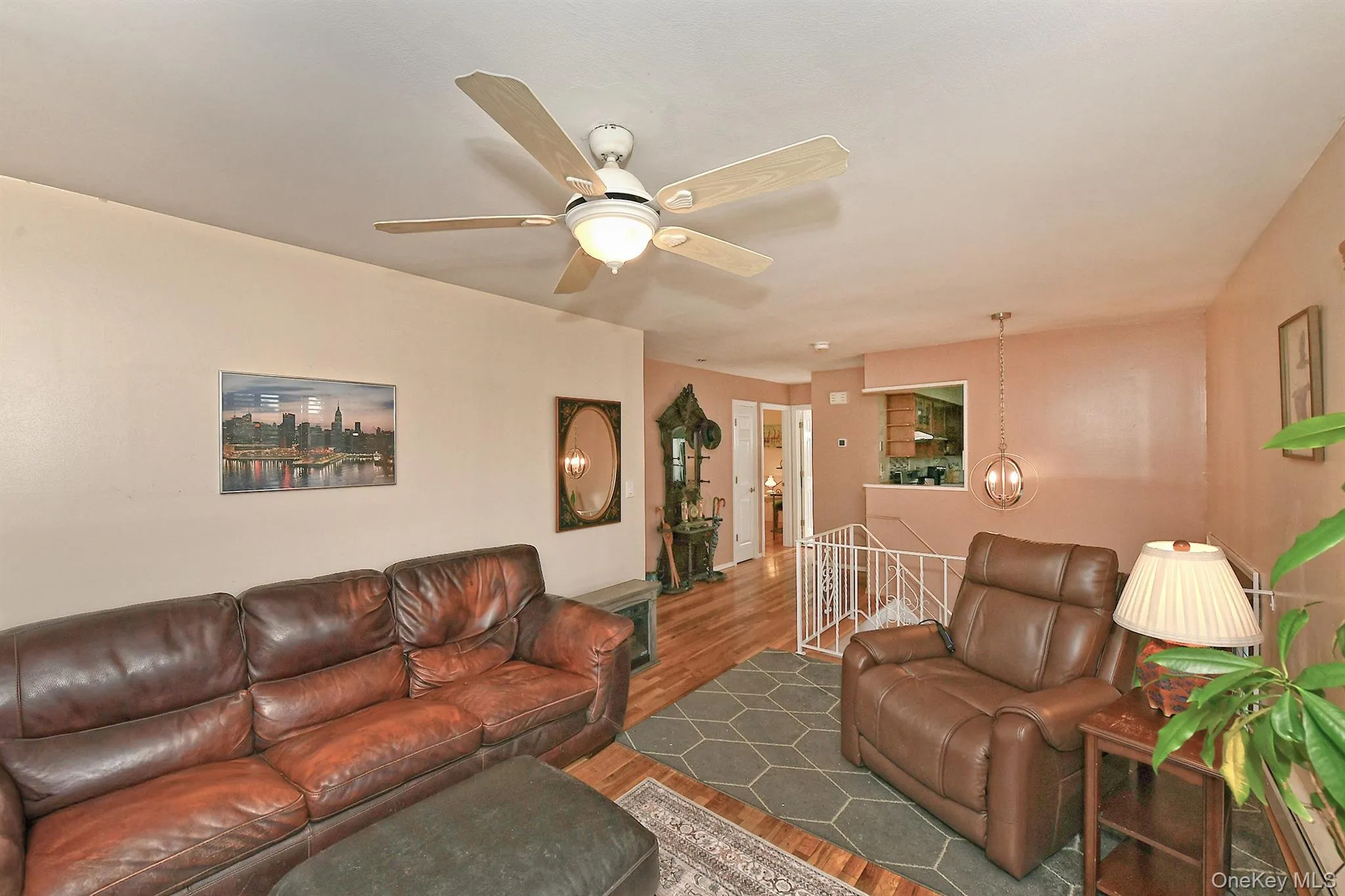 Hardwood-finish flooring, ceiling fan with integrated lighting, recessed lighting, and a kitchen pass-through window Hardwood-finish flooring, ceiling fan with integrated lighting, recessed lighting, and a kitchen pass-through window