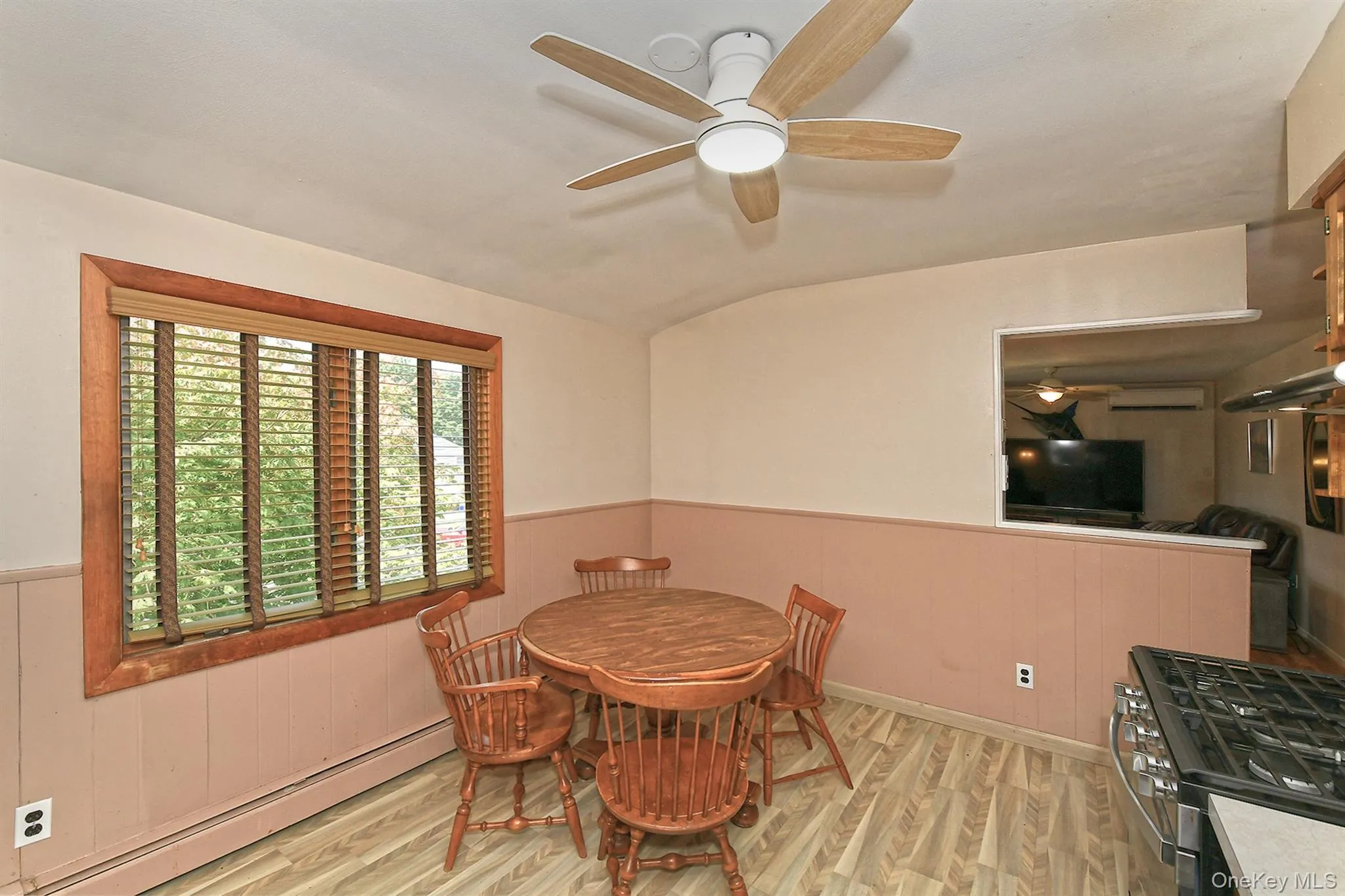 Wood-finish flooring with panel wainscoting and a built-in cooktop Wood-finish flooring with panel wainscoting and a built-in cooktop
