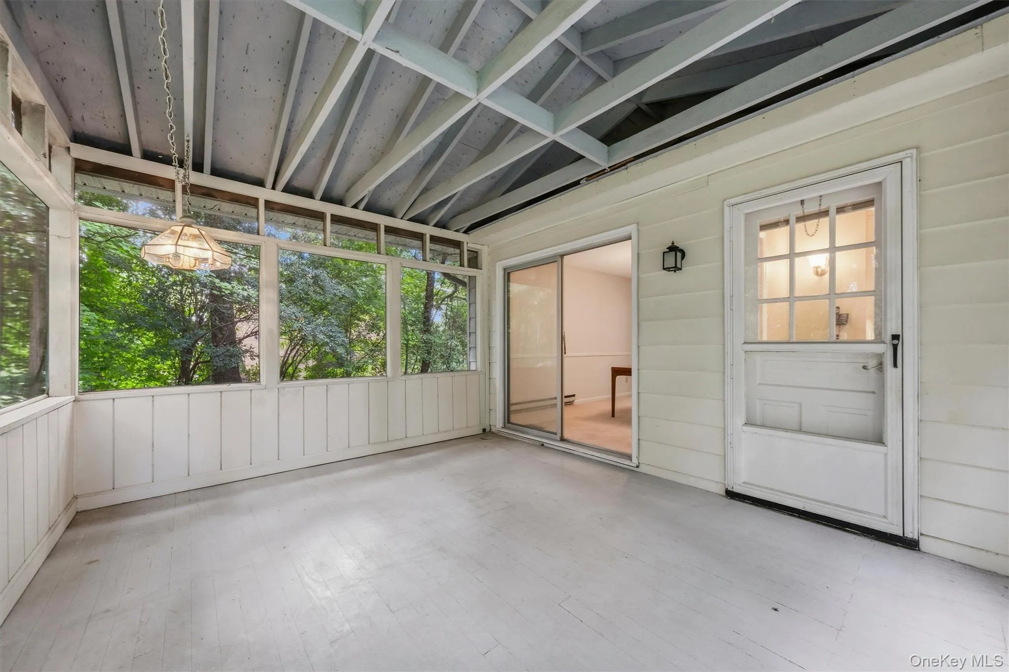 Screened porch overlooks wooded backyard Screened porch overlooks wooded backyard