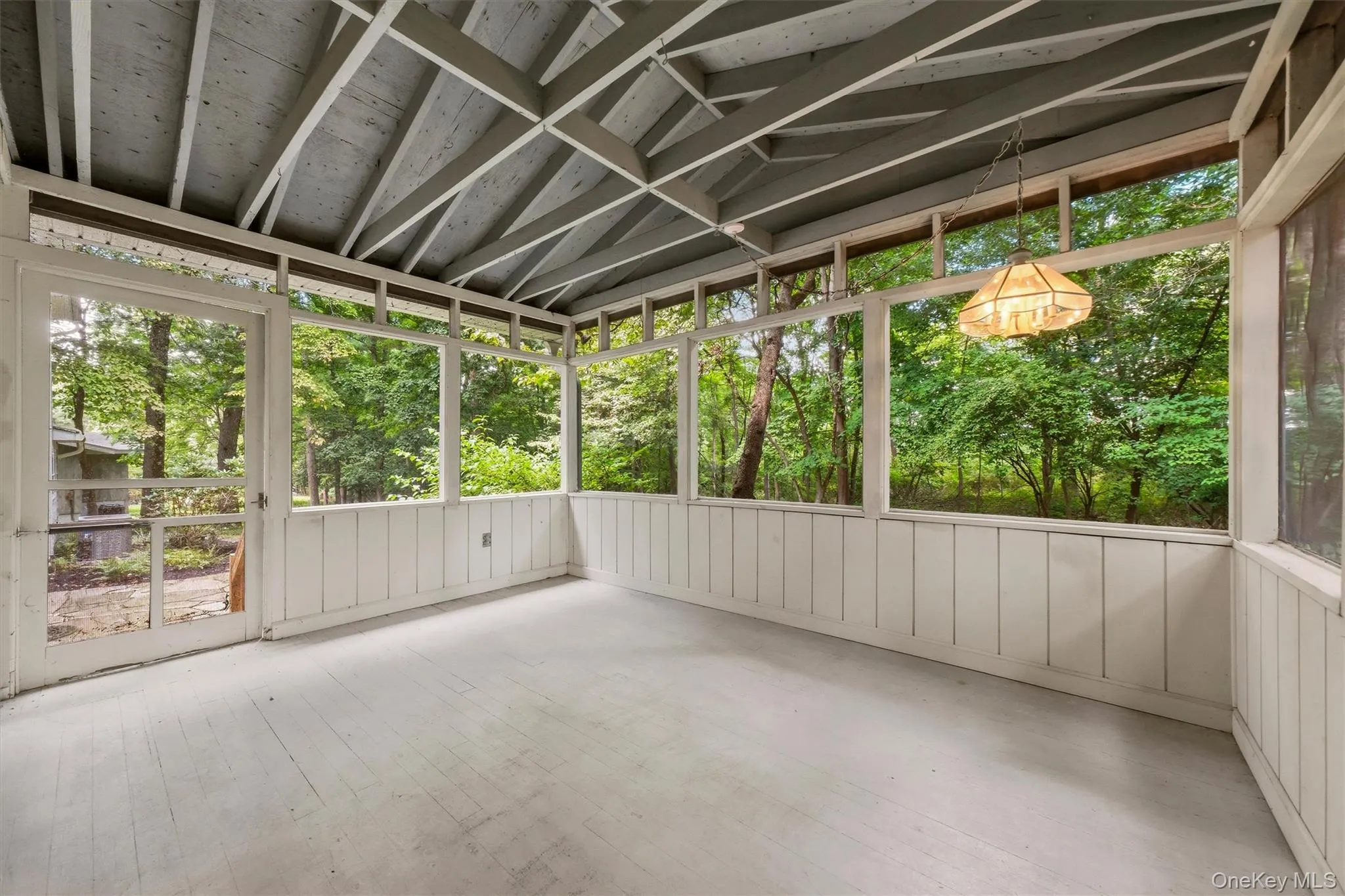 Screened porch overlooks wooded backyard Screened porch overlooks wooded backyard